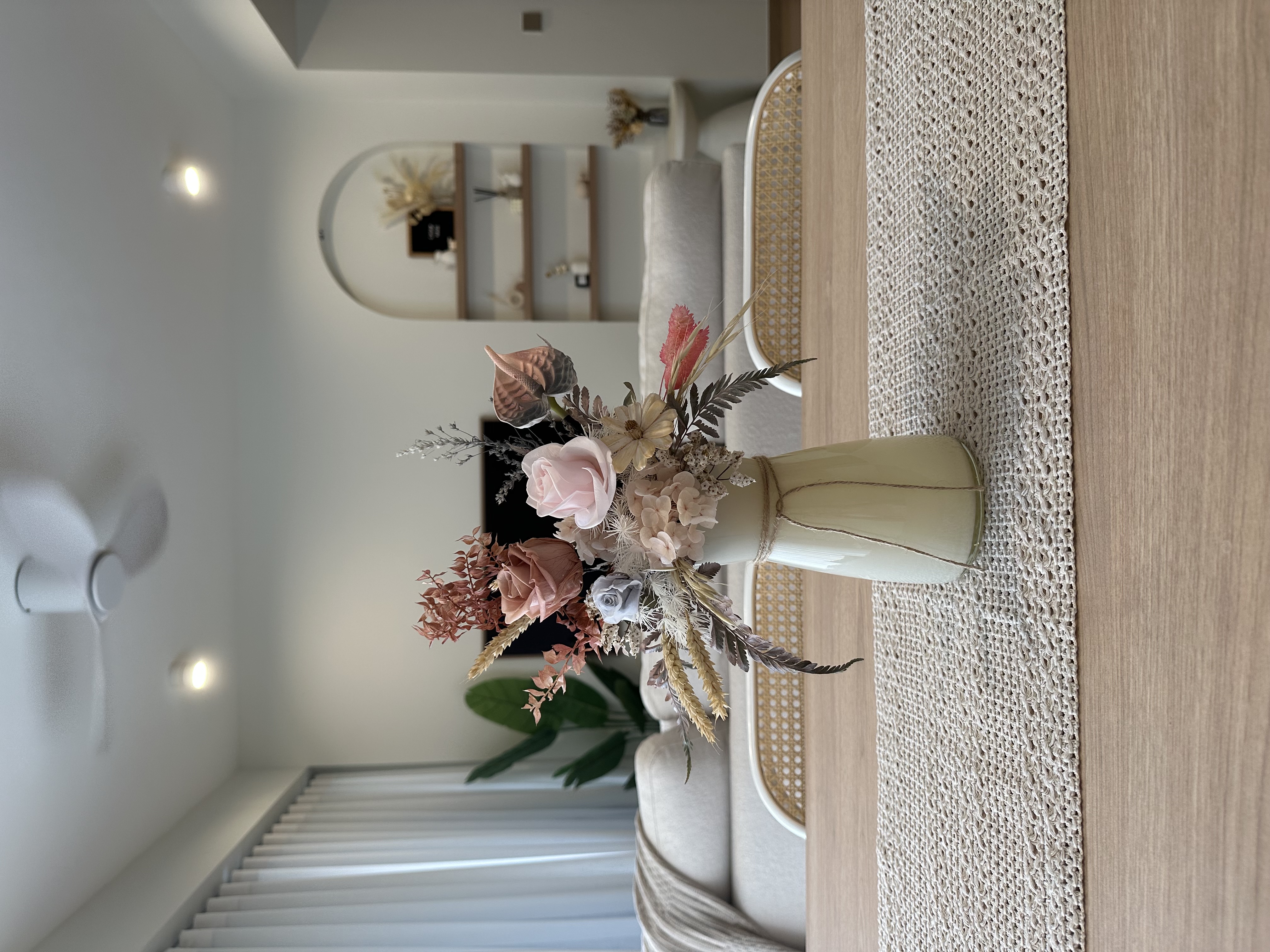 Our multi purpose dining room - vibrant floral arrangement, soft pastel colors, natural elements, cozy ambiance, modern