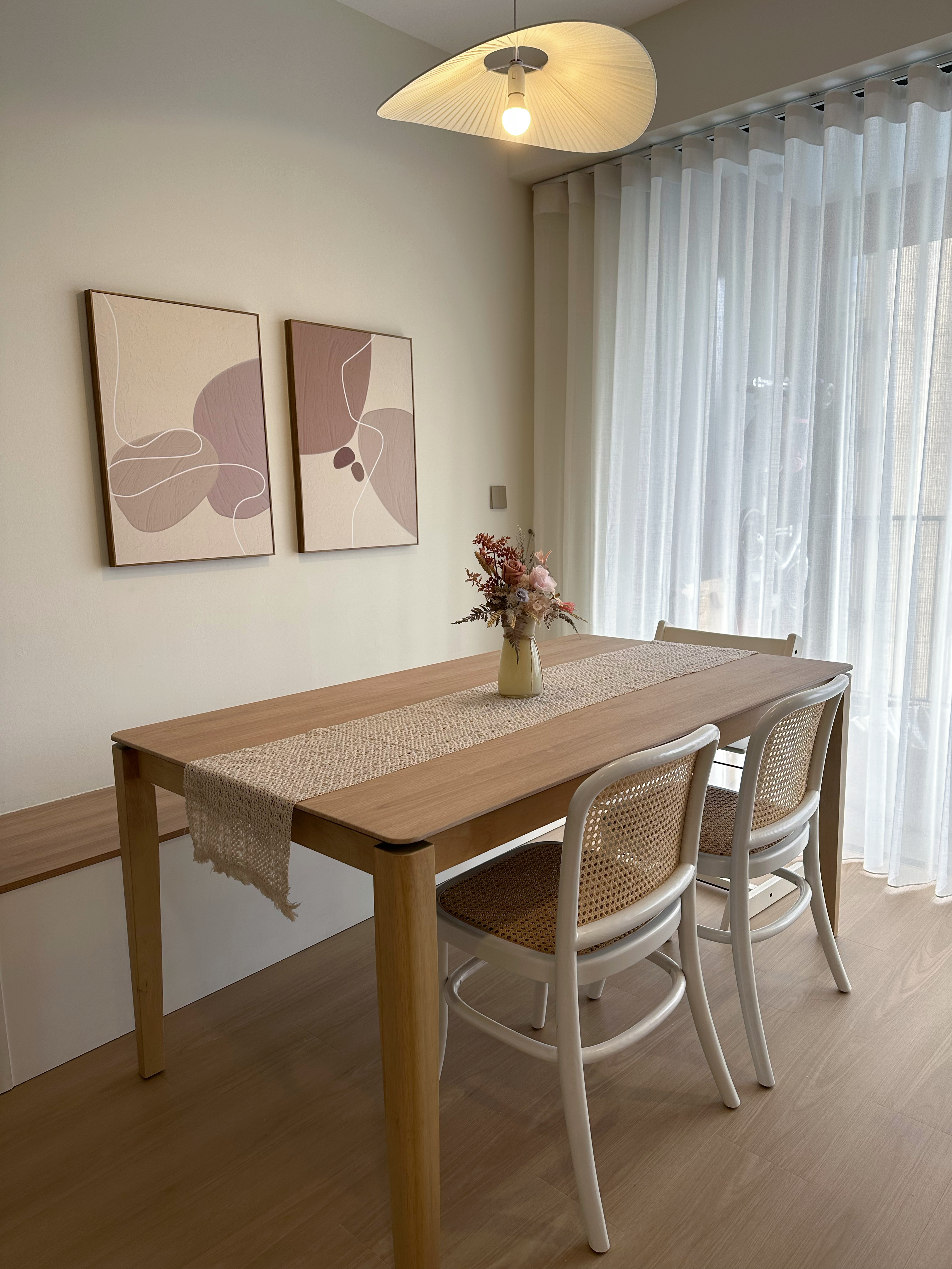 Our multi purpose dining room - Modern dining room with minimalist design, wooden dining table, woven chair, abstract art on