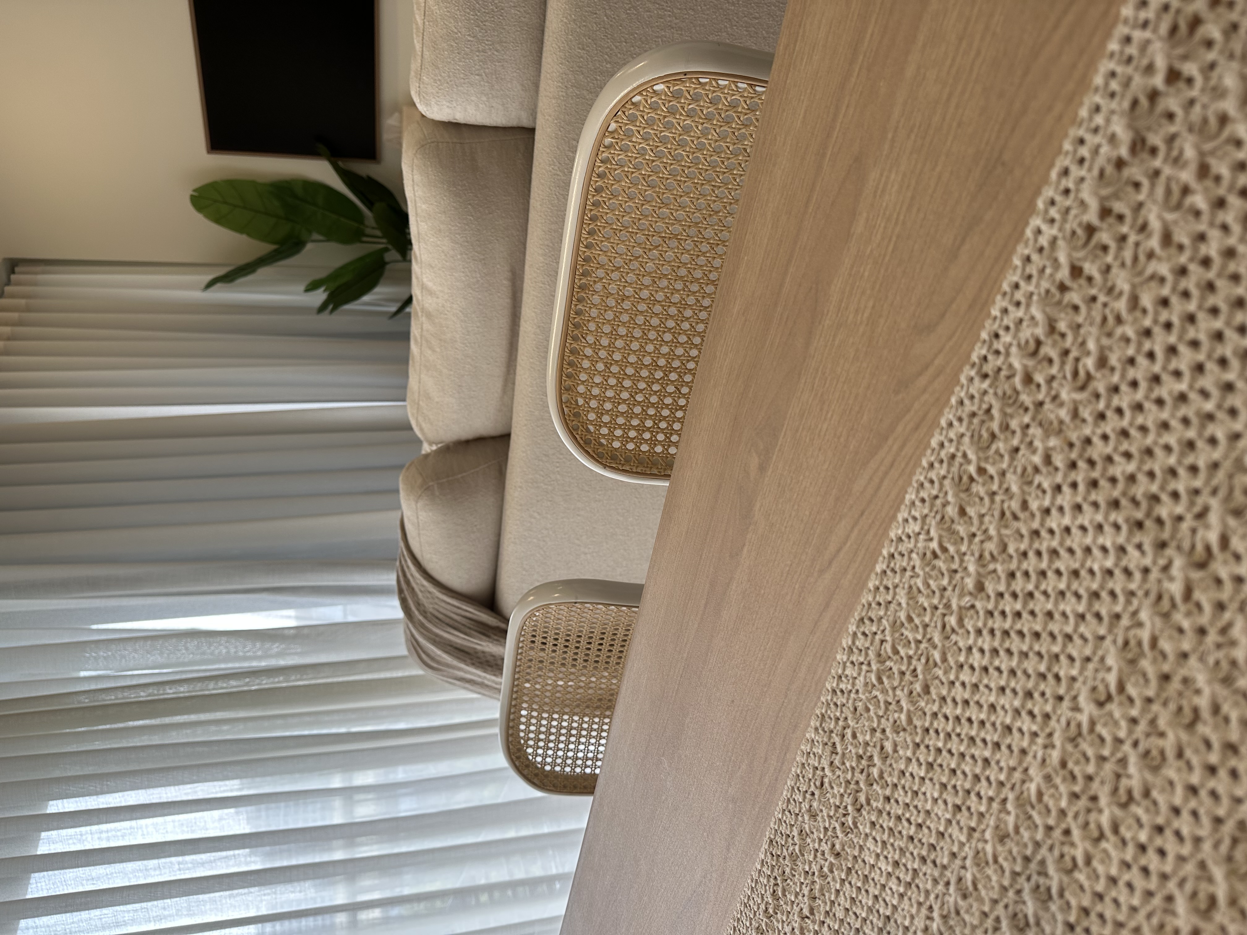 Our multi purpose dining room - Beige upholstered sofa, sheer white blinds, natural light streaming through, textured woven