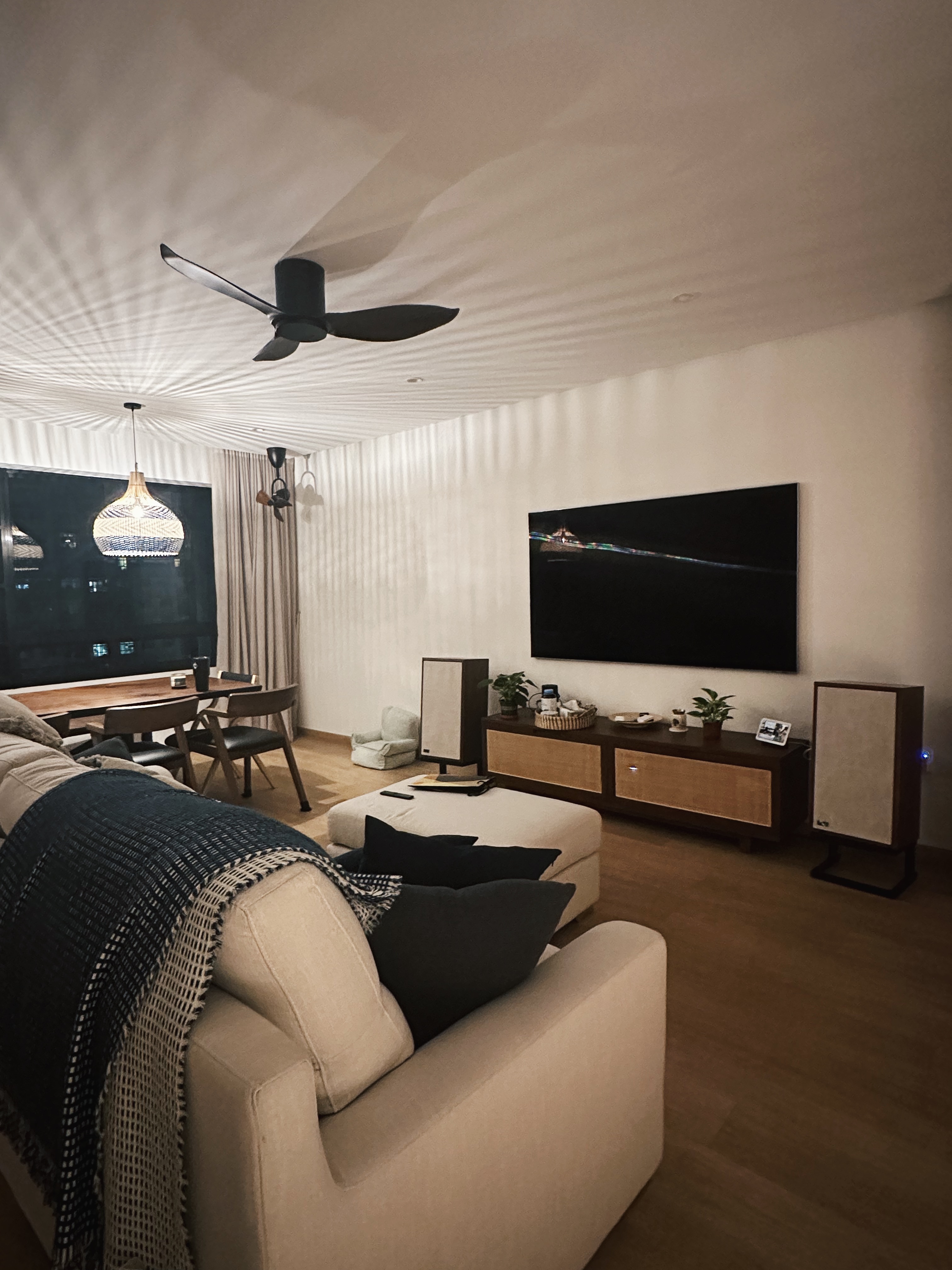 Really just warming up  - Modern living room, cozy seating, beige sofa, black and white throw blanket, wooden dining table