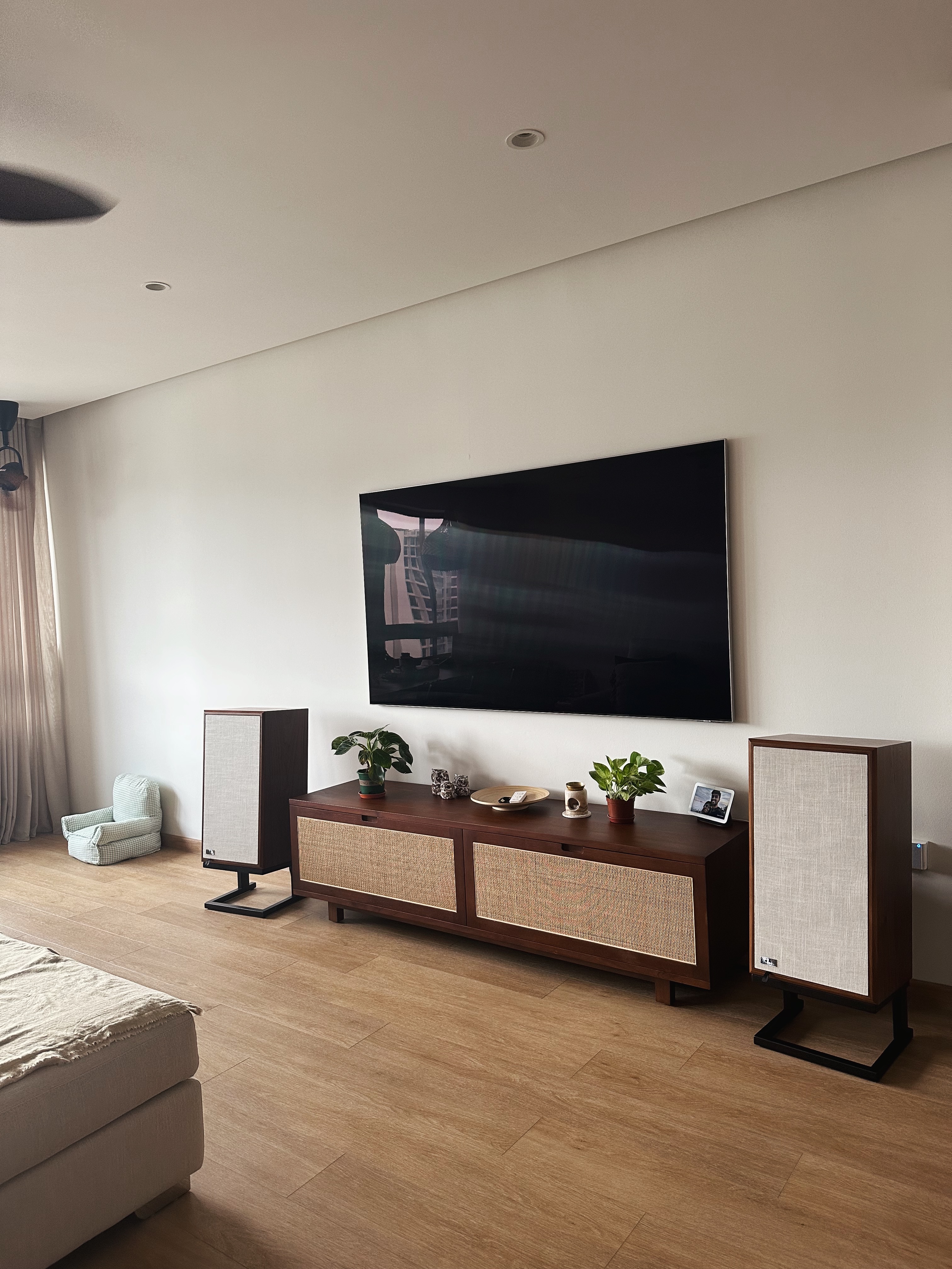 Really just warming up  - Modern minimalist living room, sleek entertainment center, large flat-screen TV, contemporary