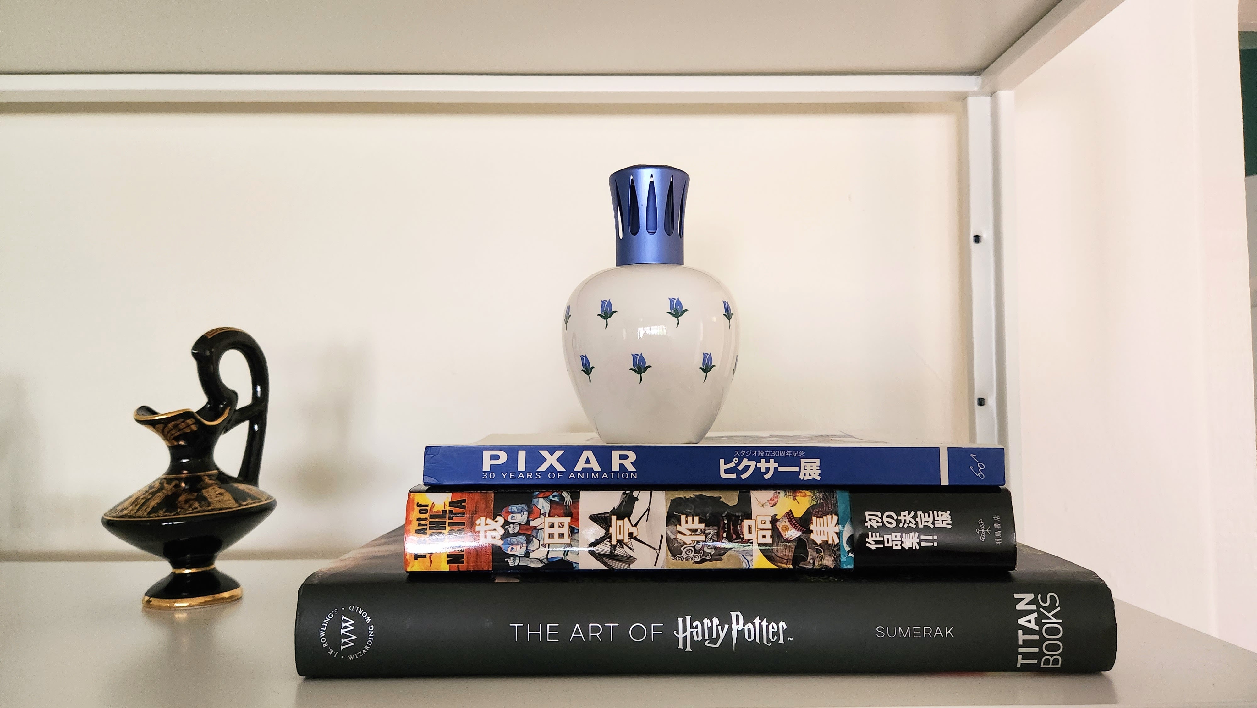 Living: injecting personal touches to a blank canvas - more to come! - vase with blue accents, black and gold pitcher, Disney