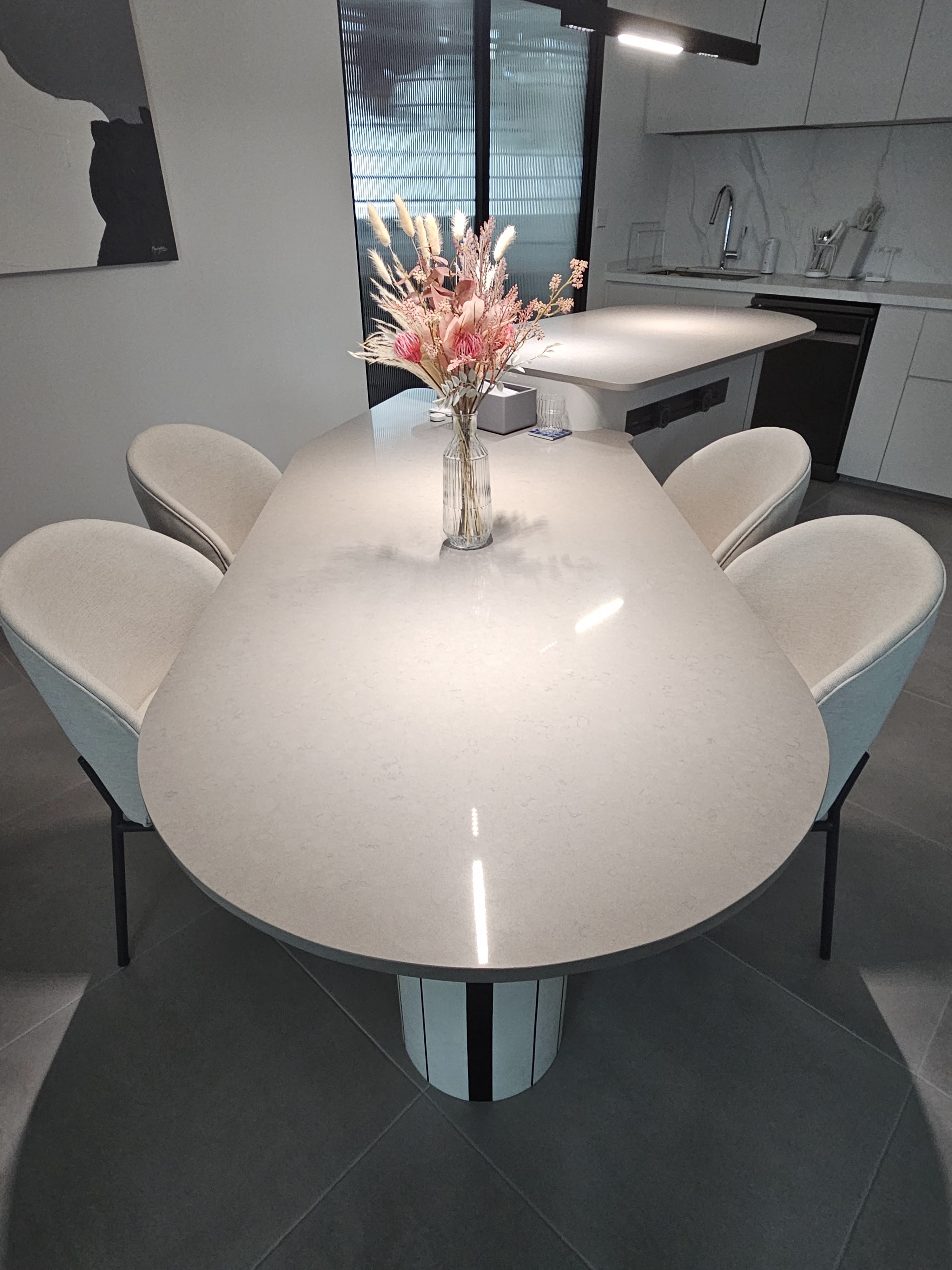 Oddly Shaped Dining Table and Island - modern dining room, minimalist kitchen, sleek furniture, oval table, soft beige