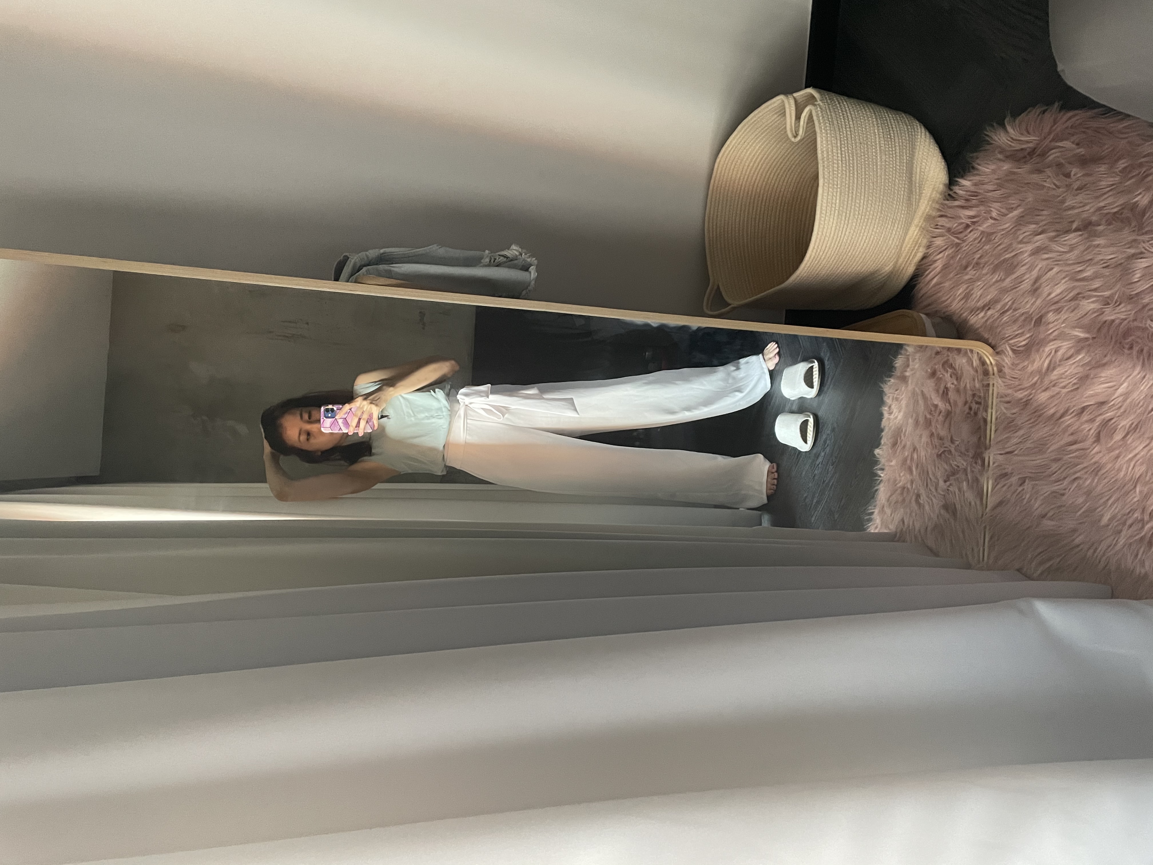 A place to rest and recharge  - White outfit, long pants, casual wear, indoor setting, person taking selfie, natural light