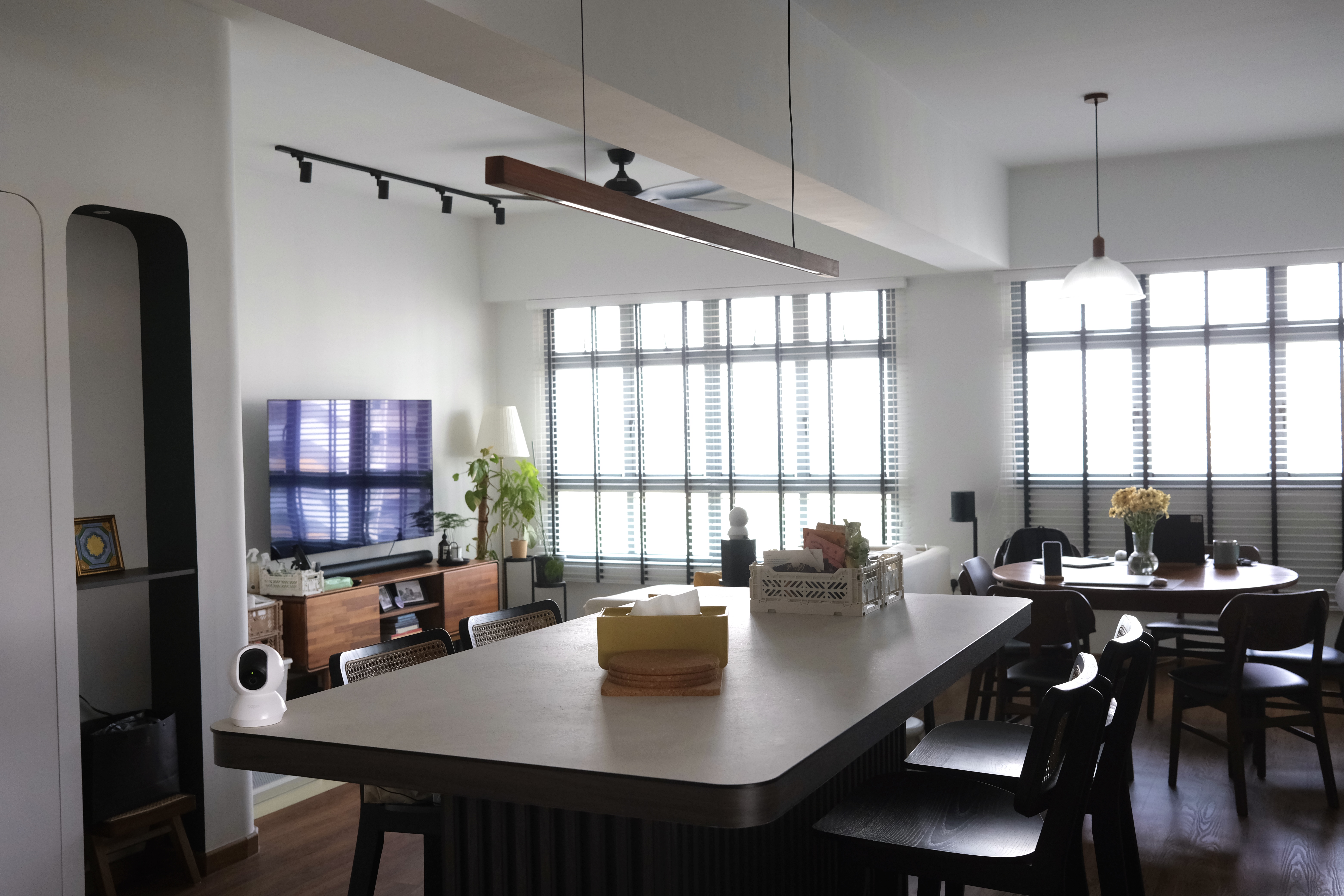 Small Spaces | Optimising the space - Modern minimalist dining room, large window with blinds, wooden furniture, black and