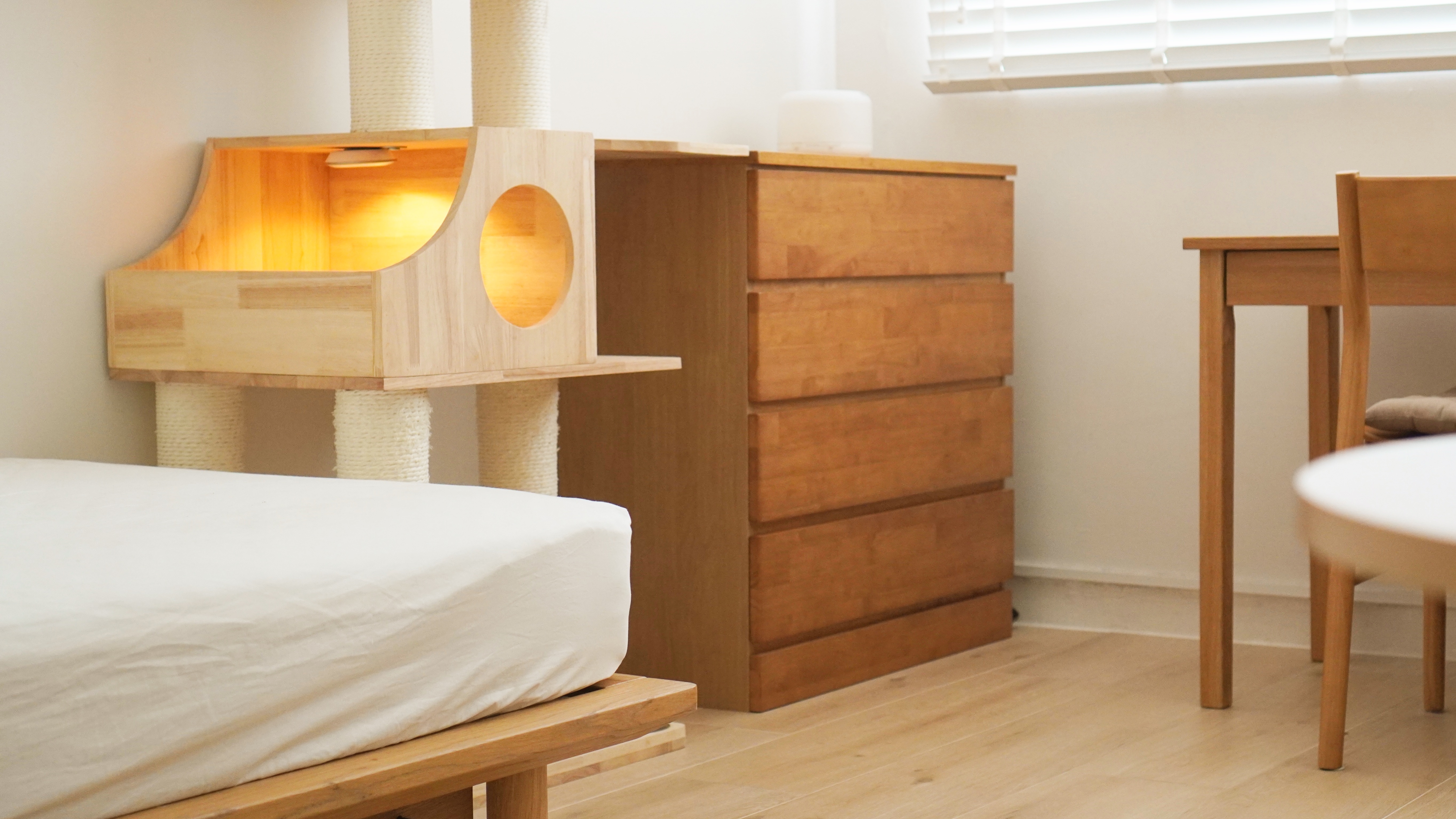 Home Decor tips in a tight space: Making the most of every inch - Wooden cat tree, cozy corner, wooden dresser, round drawer
