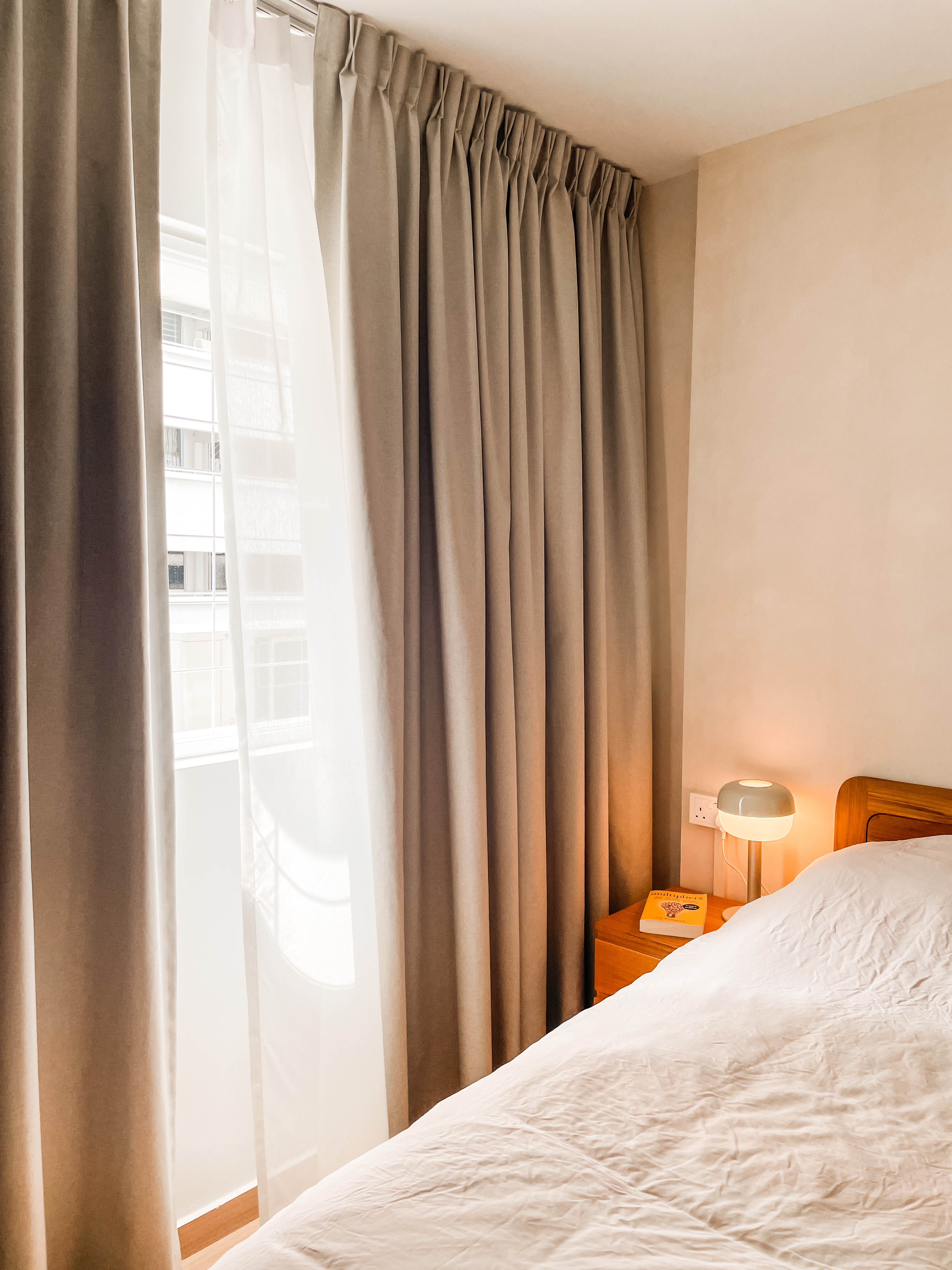 Our Master Bedroom: A Restful Retreat  - Soft beige curtains, natural light streaming, wooden headboard, cozy ambiance