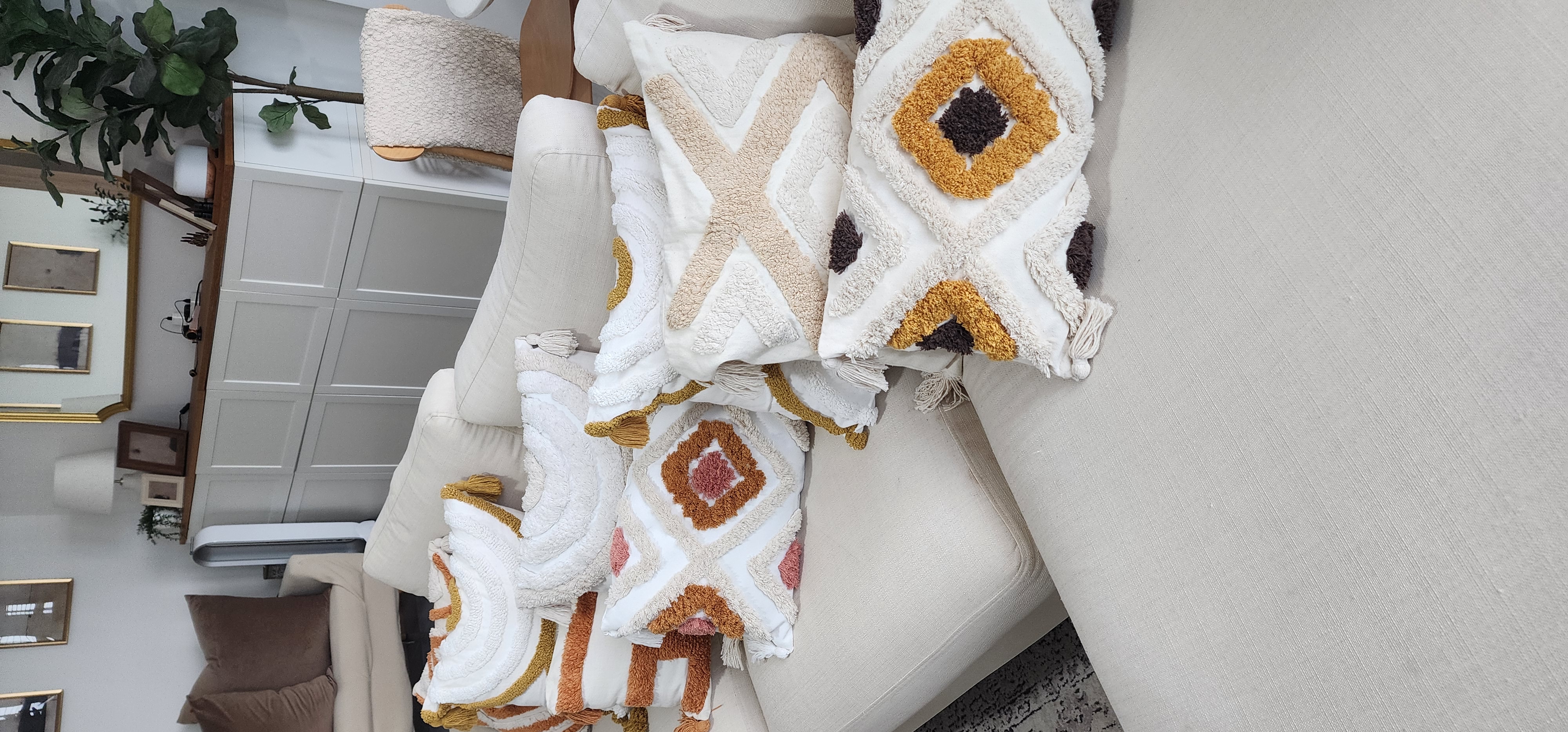 Home Decor is your answer to happiness!  - Cream sofa, beige cushions, decorative pillows, geometric pattern, warm lighting