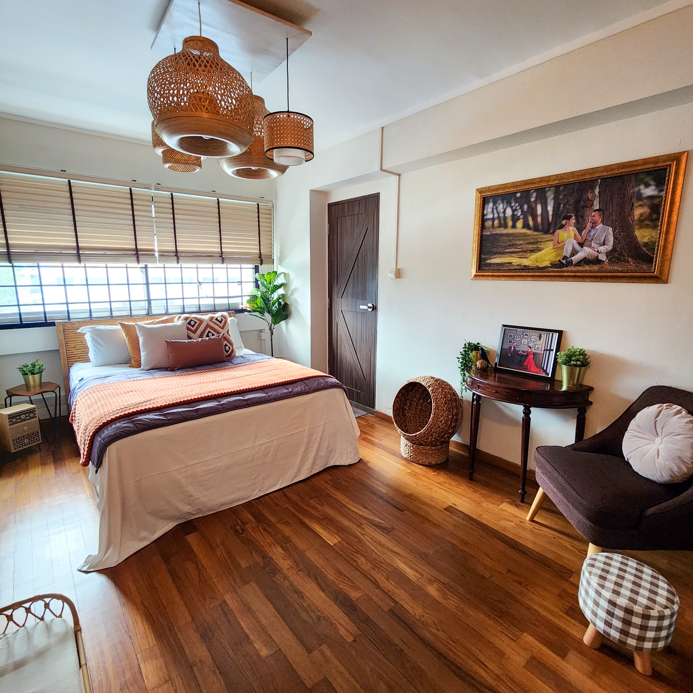 Cosy Escapade - Wooden floor, cozy bedroom, natural light, wicker furniture, comfortable seating, framed picture, indoor