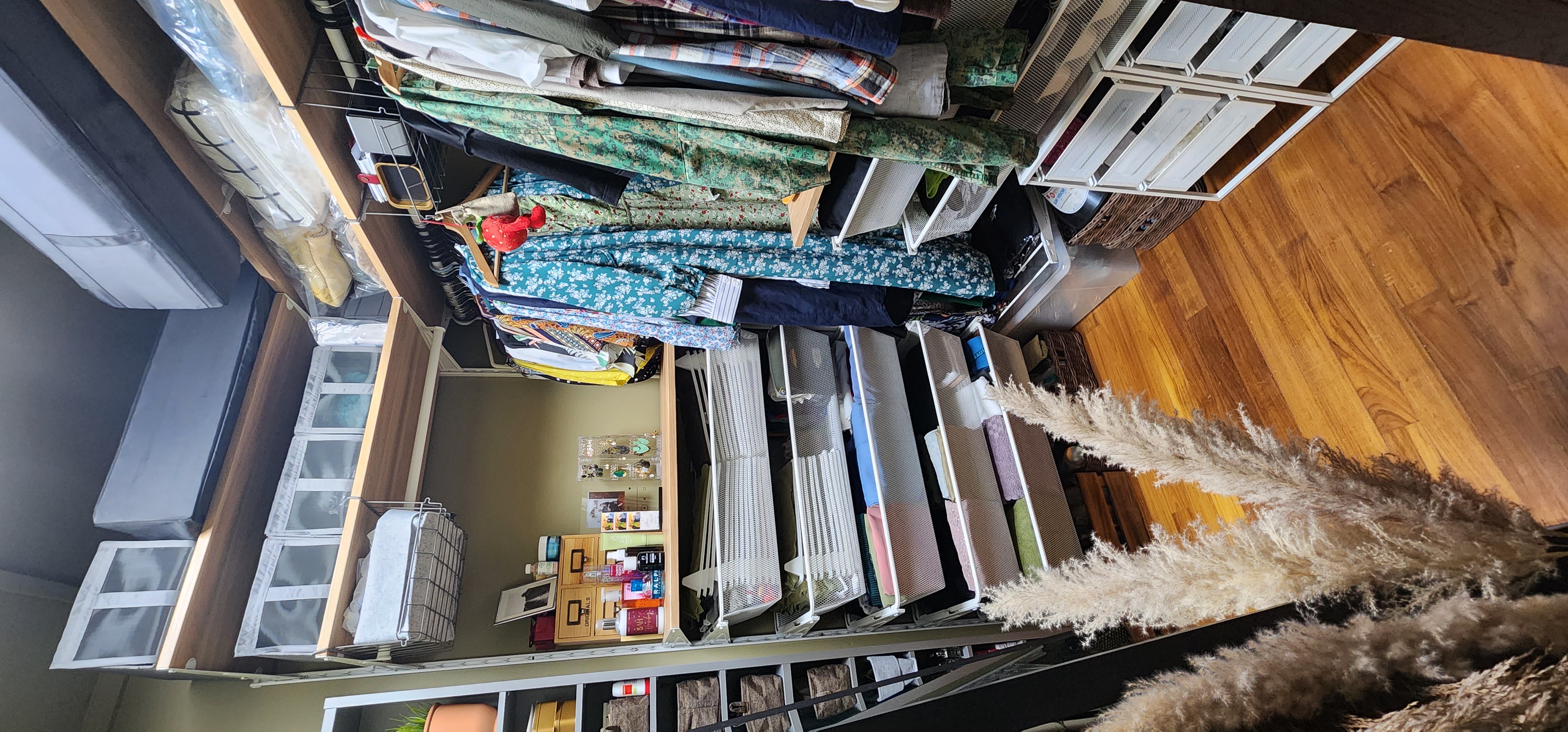 Cosy Escapade - Organized closet with various clothes, neatly folded garments, hanging clothes, clothes hangers, clothes