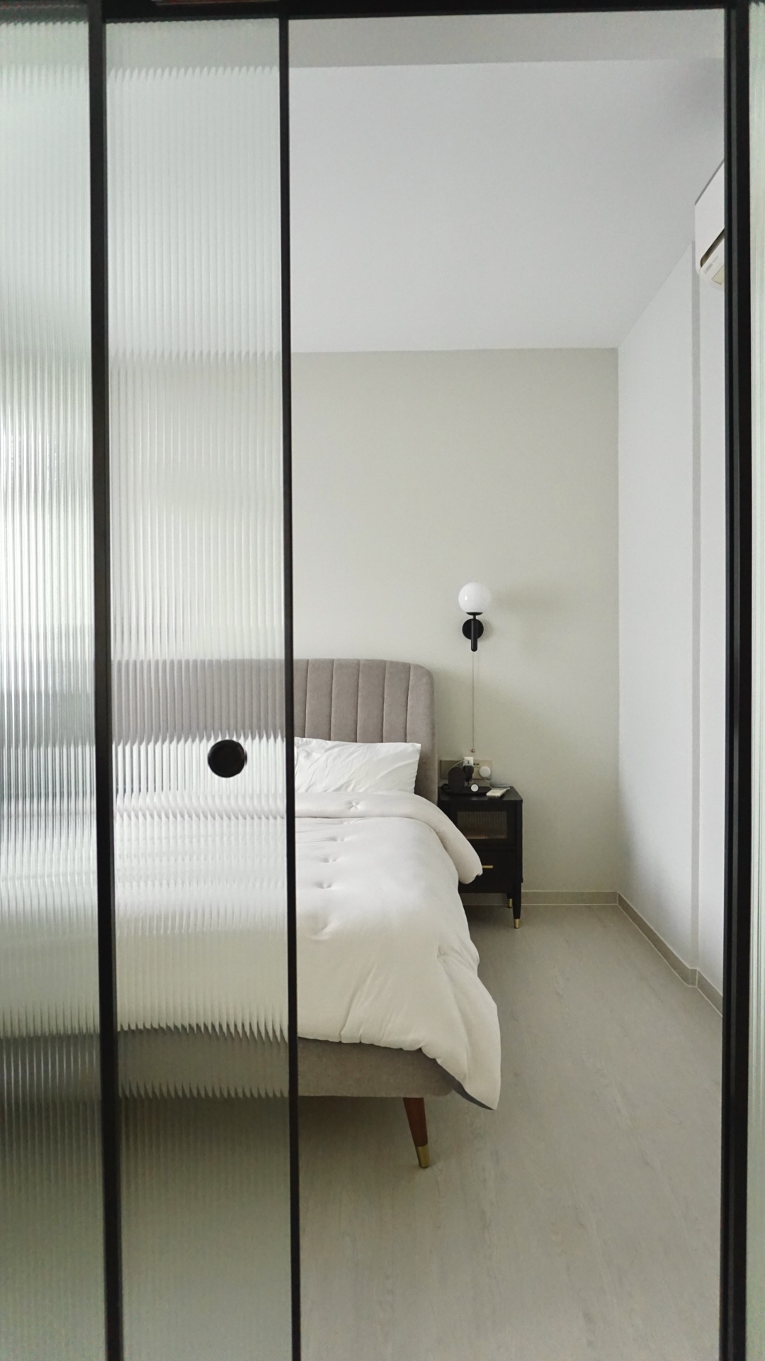 Our bedroom; the room behind the reeded glass doors - Modern minimalist bedroom, sleek bed frame, white bedding, gray