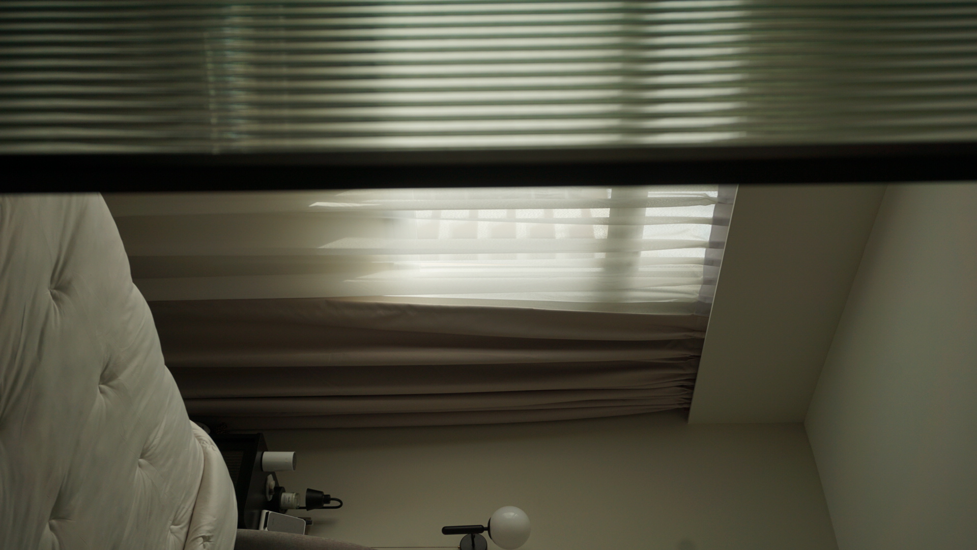 Our bedroom; the room behind the reeded glass doors - Sunlight filtering through blinds, soft beige curtains, cozy bedroom