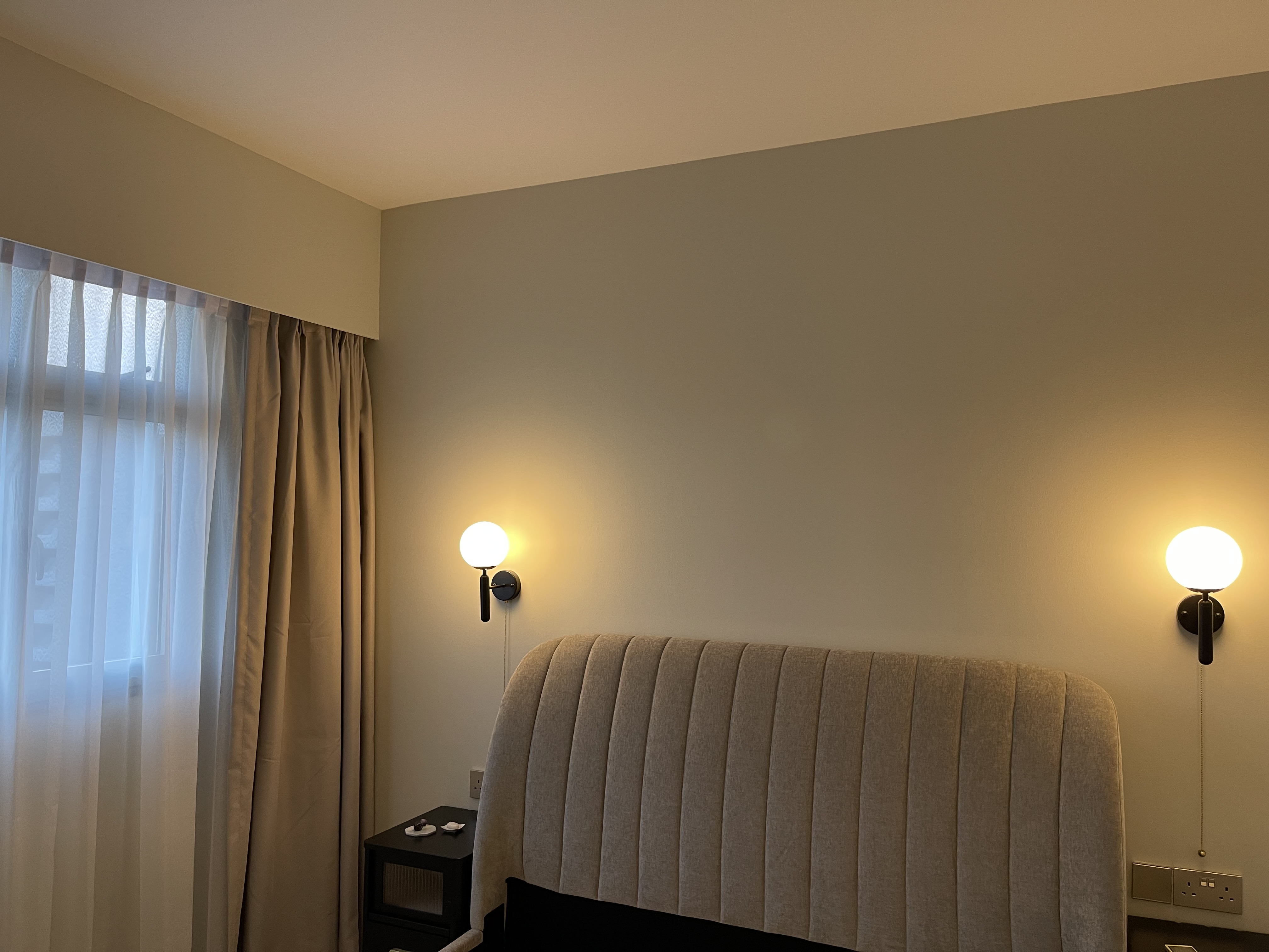 Our bedroom; the room behind the reeded glass doors - Soft, neutral-toned walls, minimalist design, cozy ambiance, modern