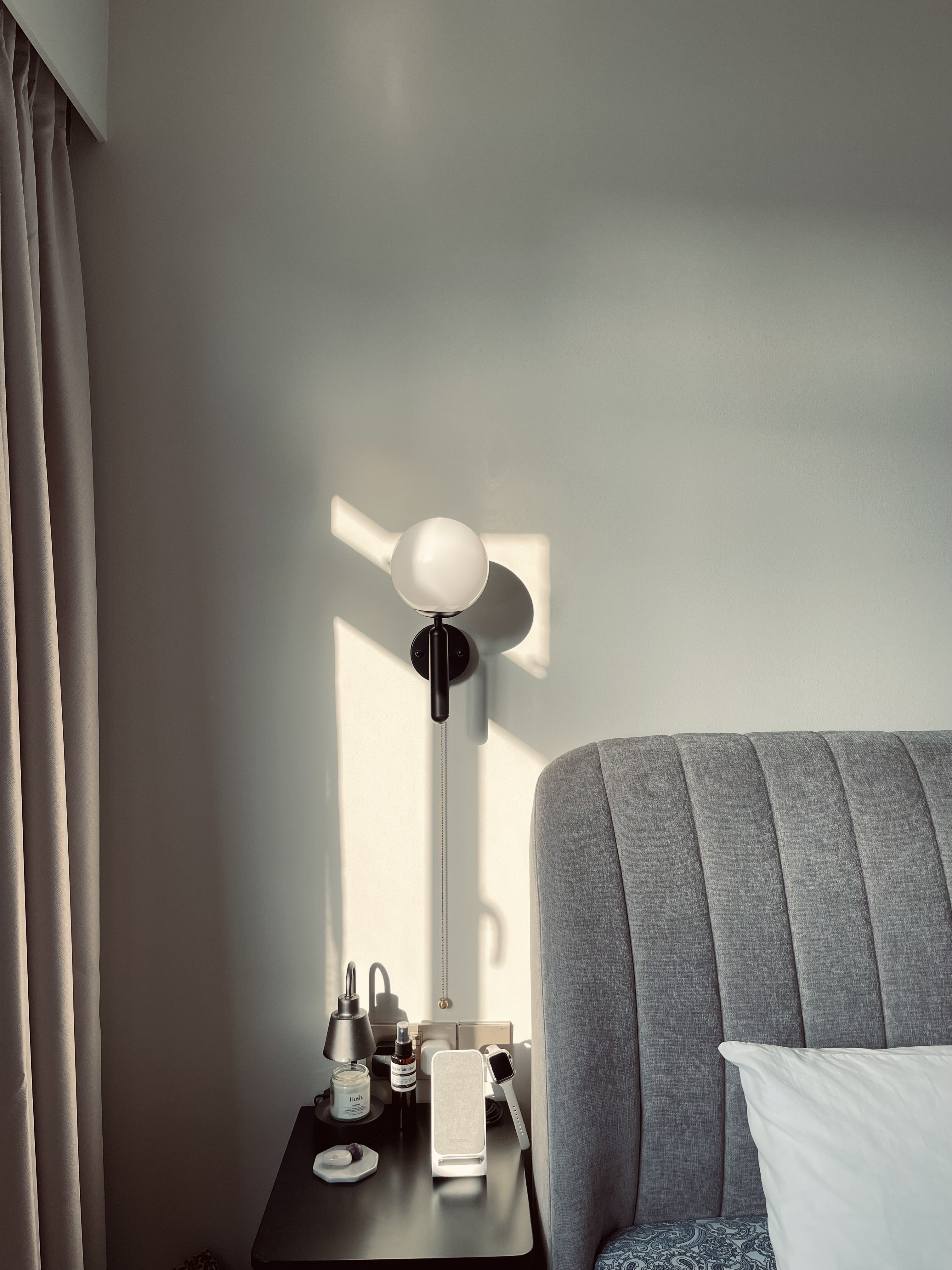 Our bedroom; the room behind the reeded glass doors - Modern minimalist bedroom, soft natural light, gray upholstered