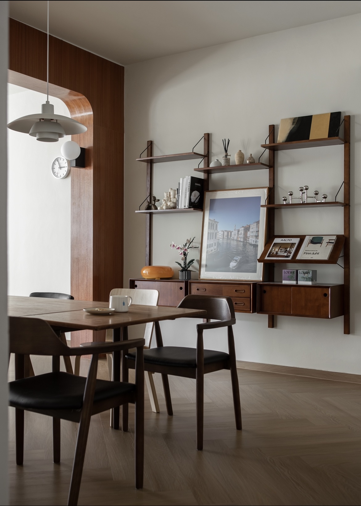 Mid Century Modern Dining Room - Wooden dining table, minimalist decor, modern interior, wooden shelves, black chairs, framed