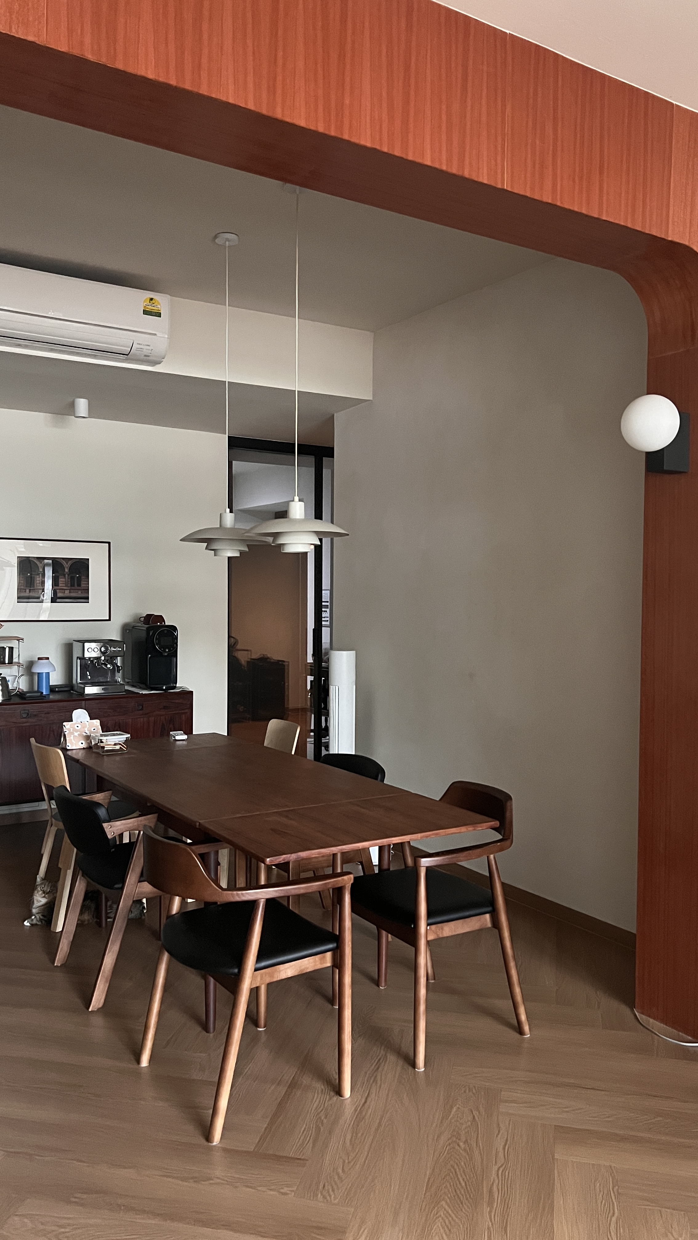 Mid Century Modern Dining Room - Wooden dining table, modern chairs, minimalist decor, warm lighting, wooden flooring