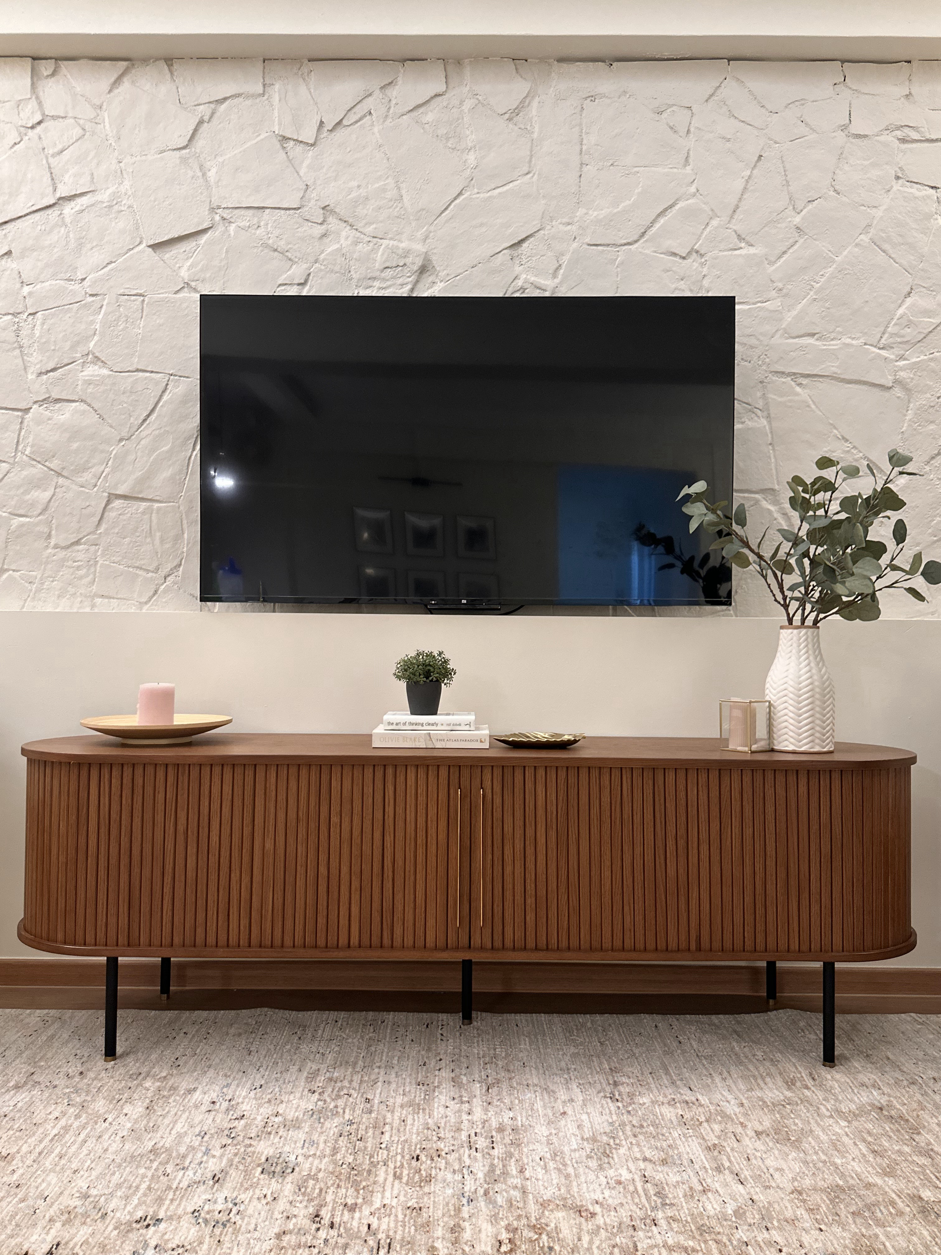 Upgrade outdated wall  - modern living room, minimalist decor, wooden cabinet, textured wall, black TV, potted plant, white