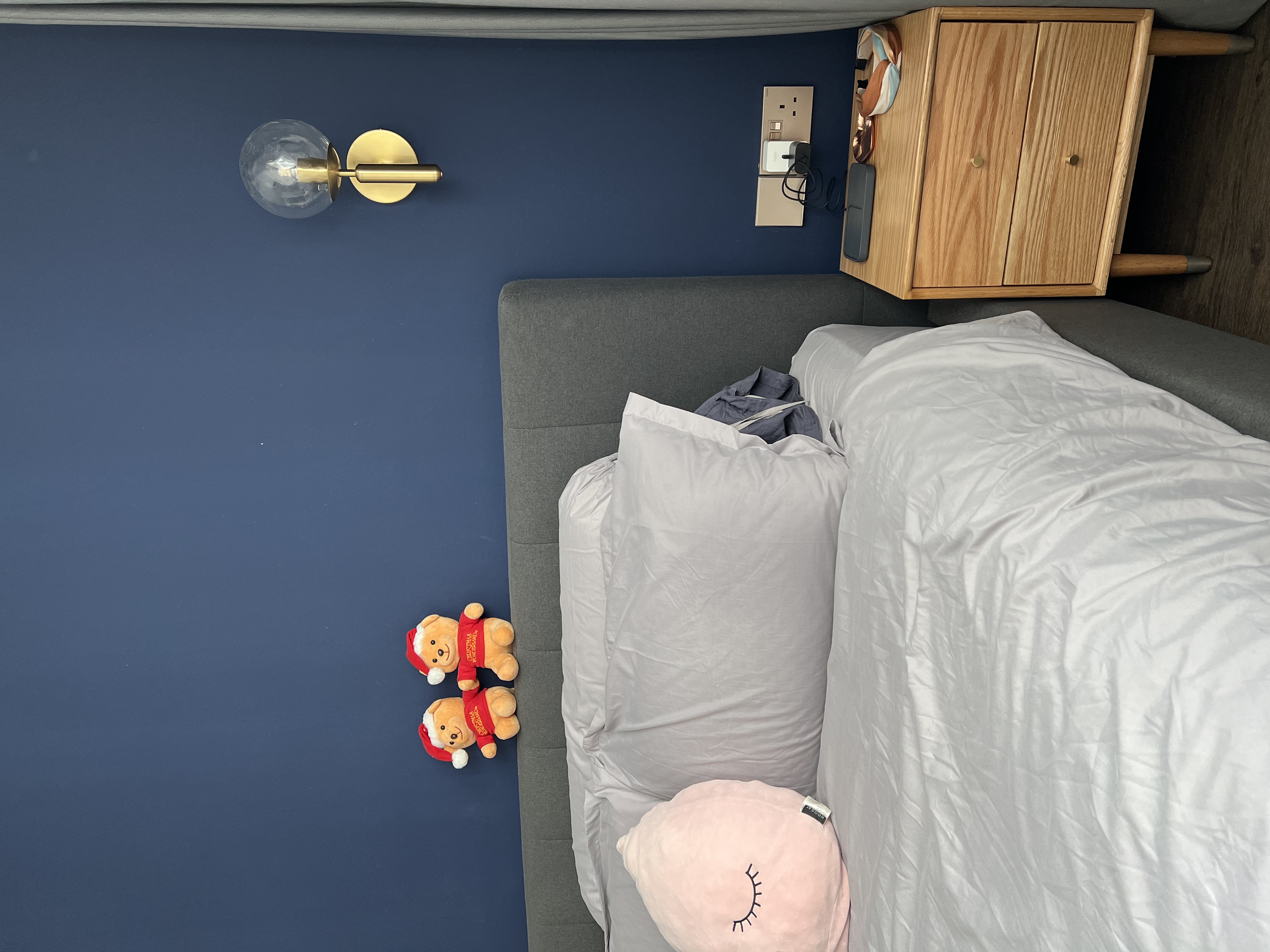 Cozy Bedroom - Nestled in comfort and warmth, where dreams take flight - blue wall, wooden nightstand, gray sofa, white