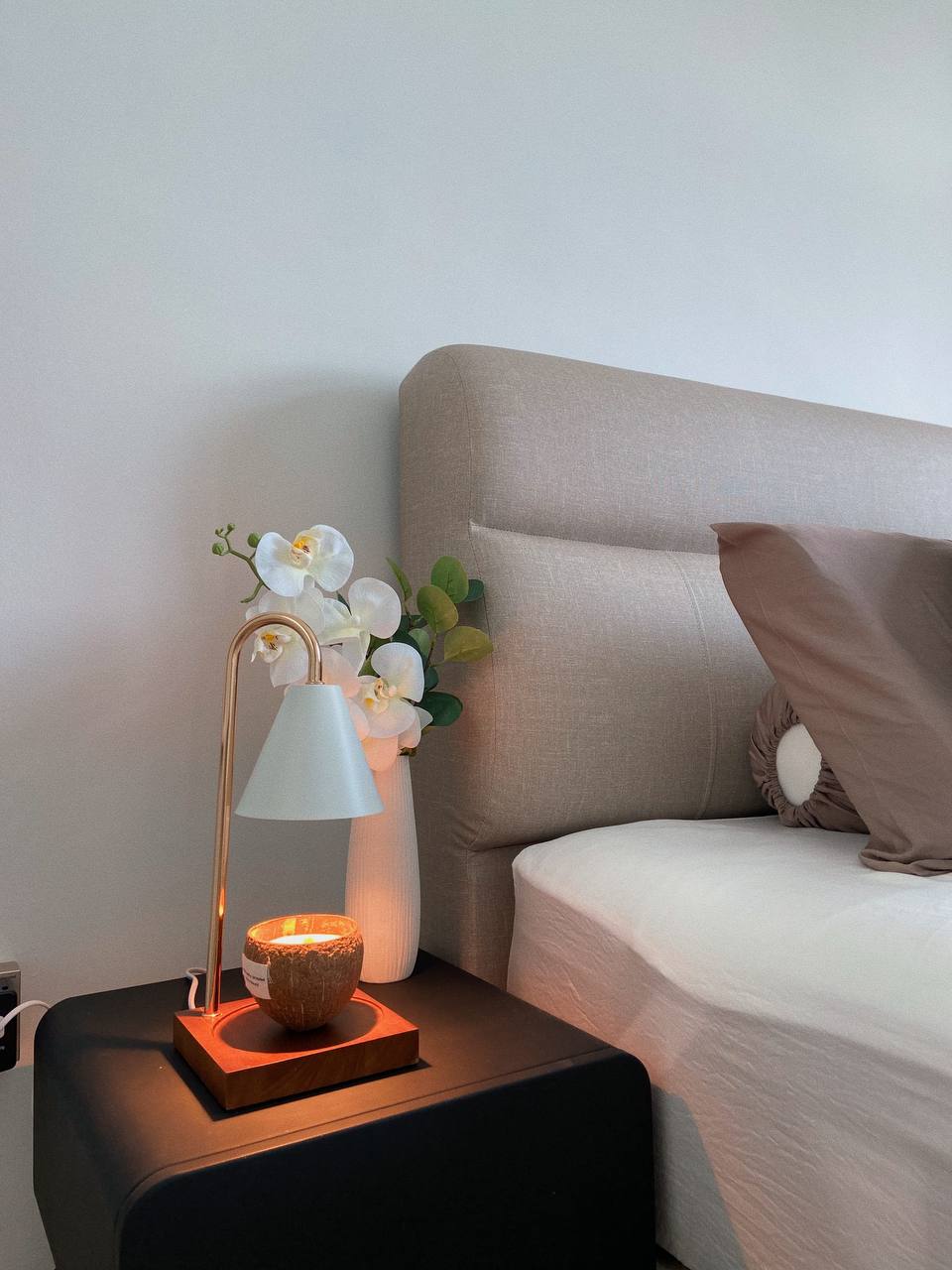 Peaceful Nights, Beautiful Mornings: Our Master Bedroom Haven - Lamp with white shade, white orchid, beige sofa, soft