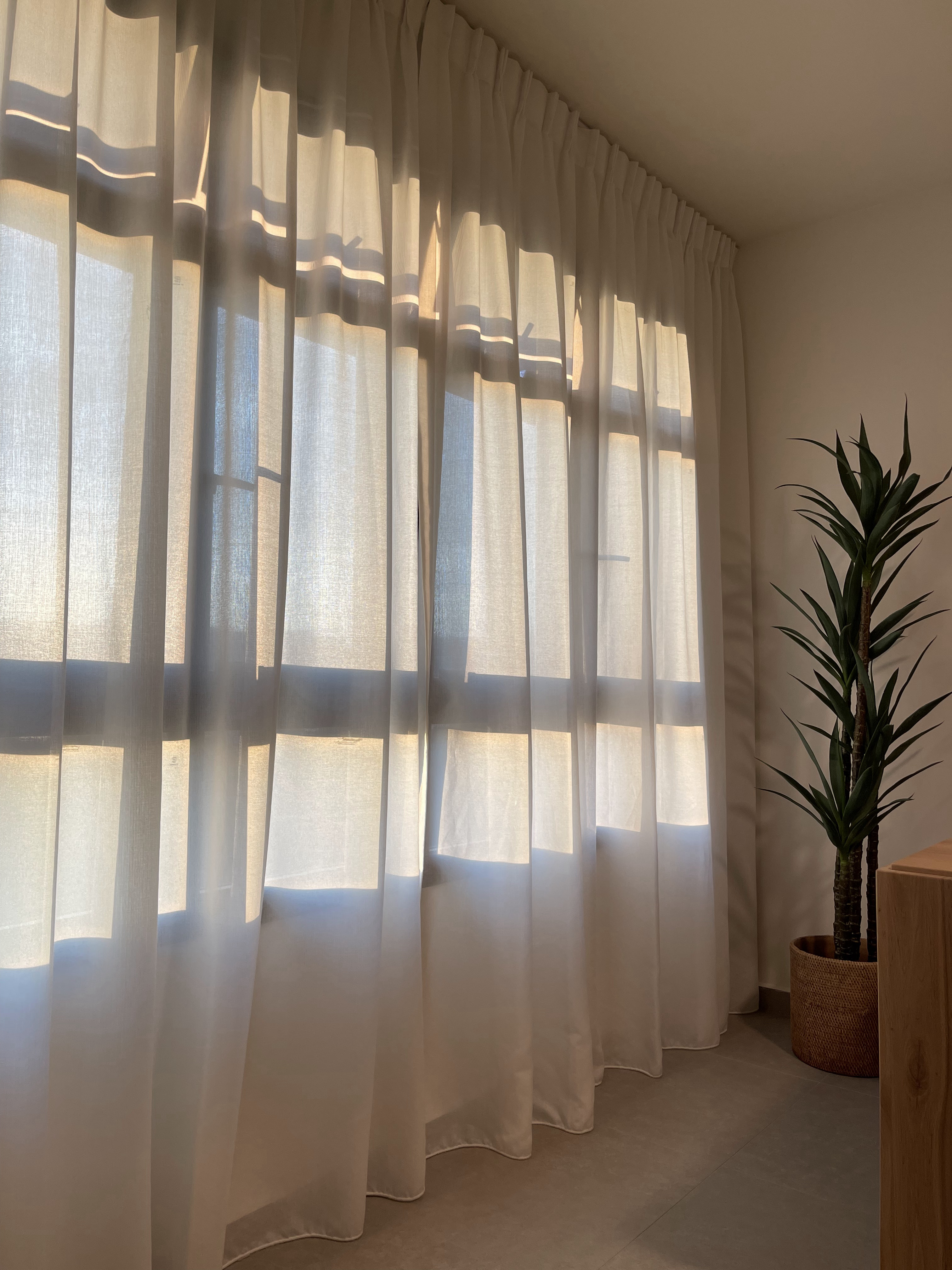 The Dining Area: The Heart of Our Home  - Sunlight filtering through sheer curtains, soft shadows cast on the floor, large