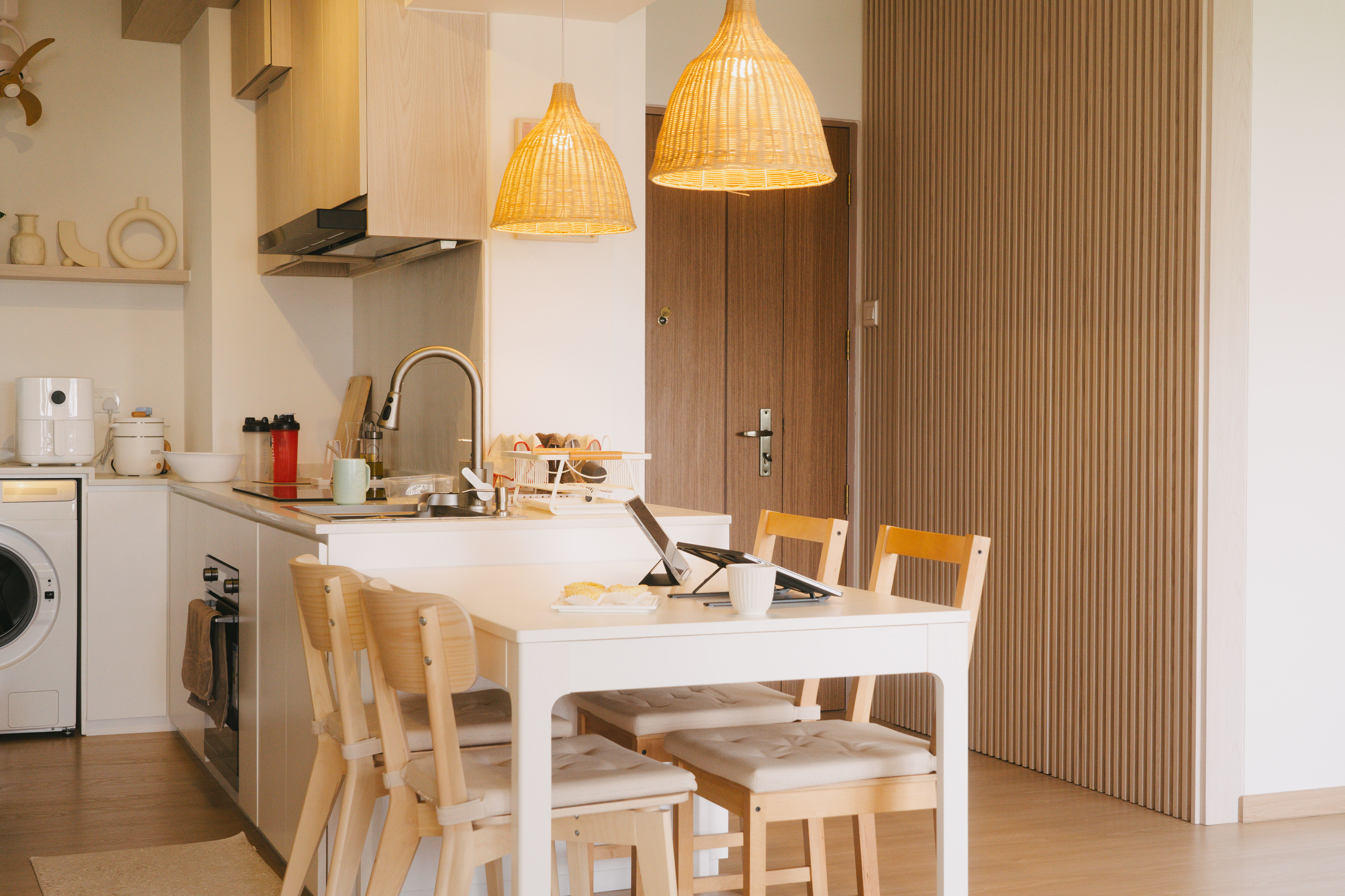A place where food and conversations meet – Dining area - Wooden dining table with beige cushioned chairs, modern kitchen