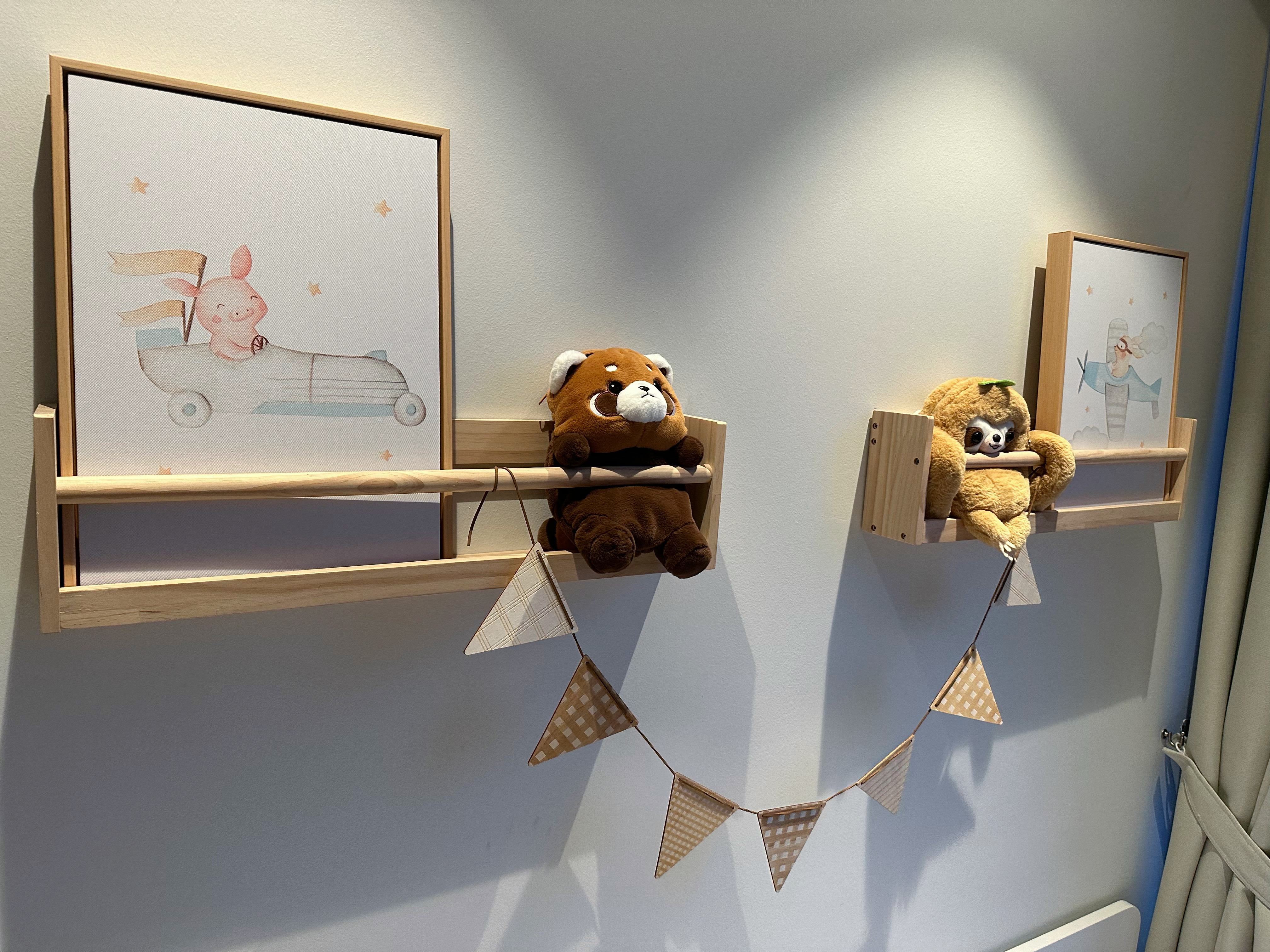 Kids bedroom built to grow with the kids - Wall-mounted shelves, plush toys, teddy bears, pastel colors, wooden frames, cute