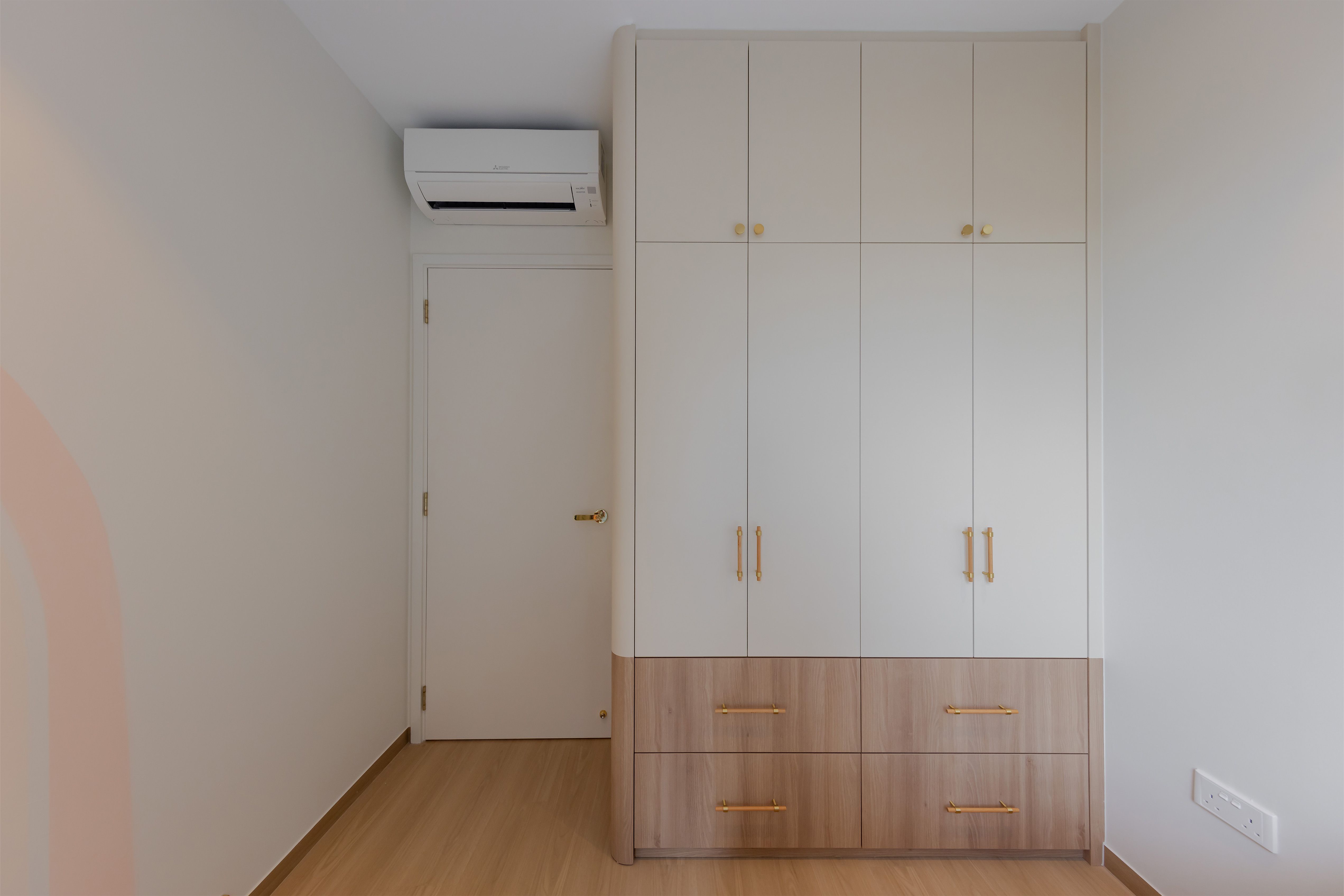 Kids bedroom built to grow with the kids - White air conditioning unit, beige wardrobe, wooden floor, minimalist design