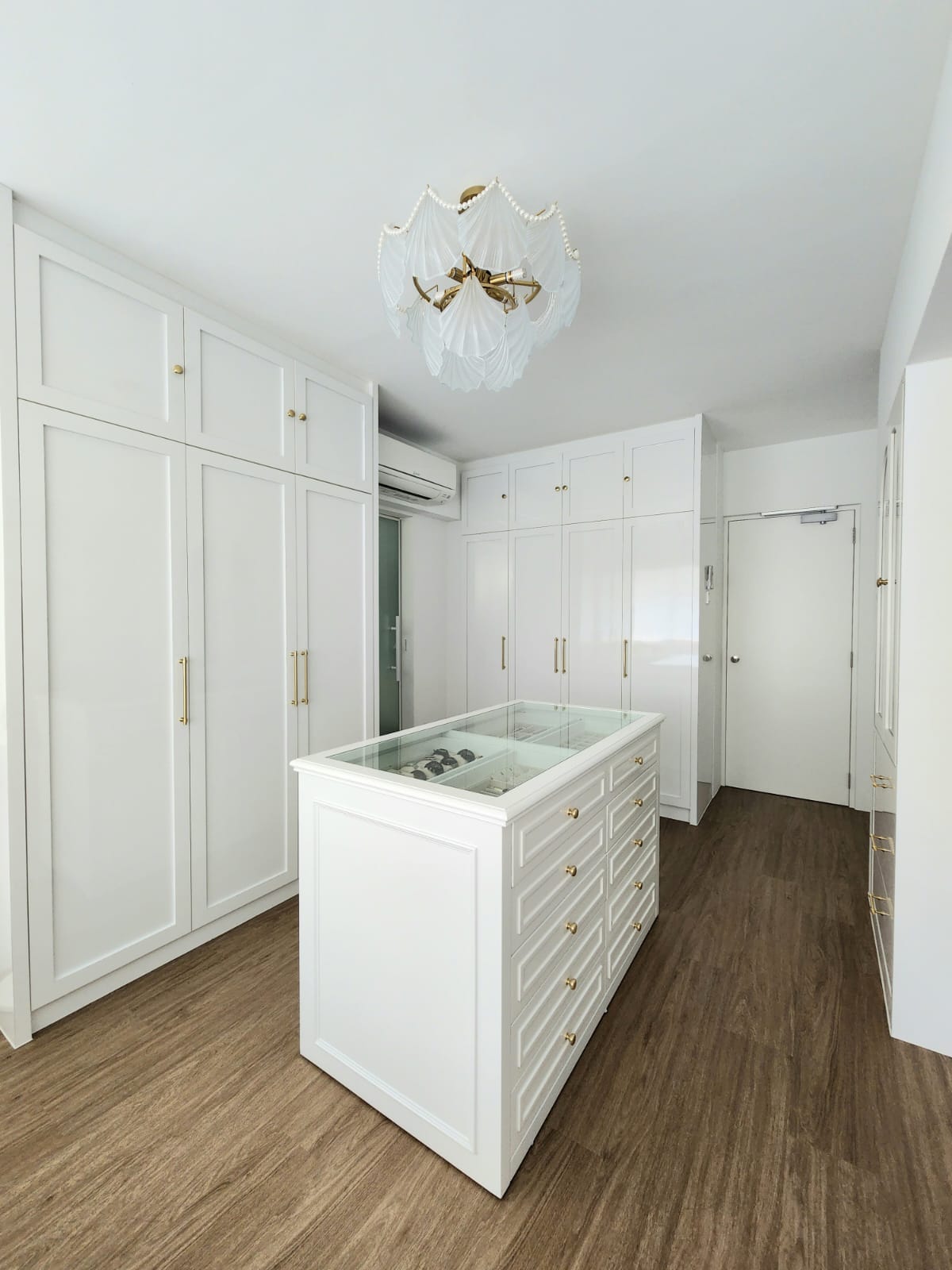 A bedroom with walk-in wardrobe  - White cabinetry, glass display case, elegant design, minimalist style, modern kitchen