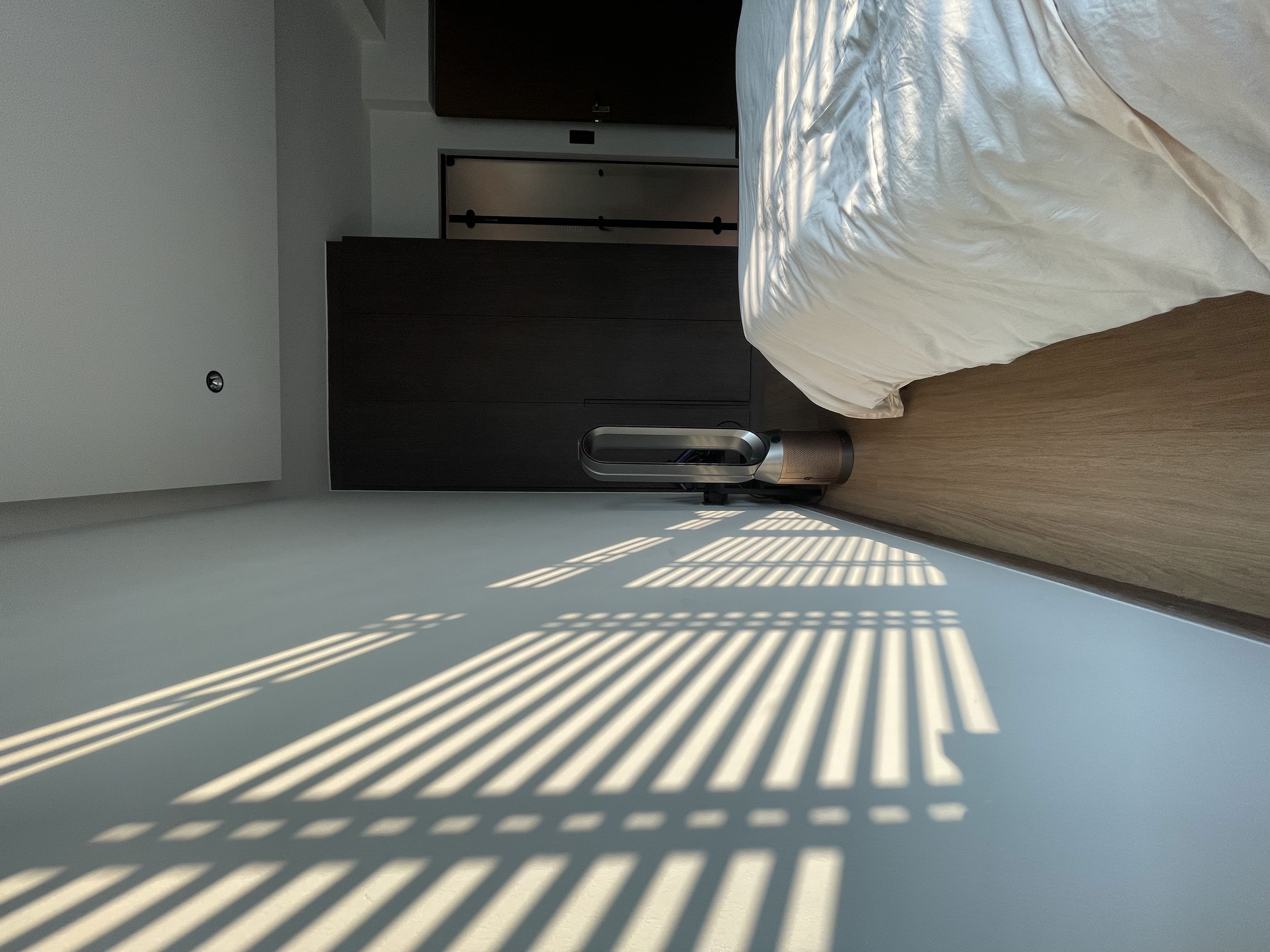 Day / Night : Our Master Bedroom - Sunlight casts intricate shadows on the floor, creating a pattern of light and dark. The