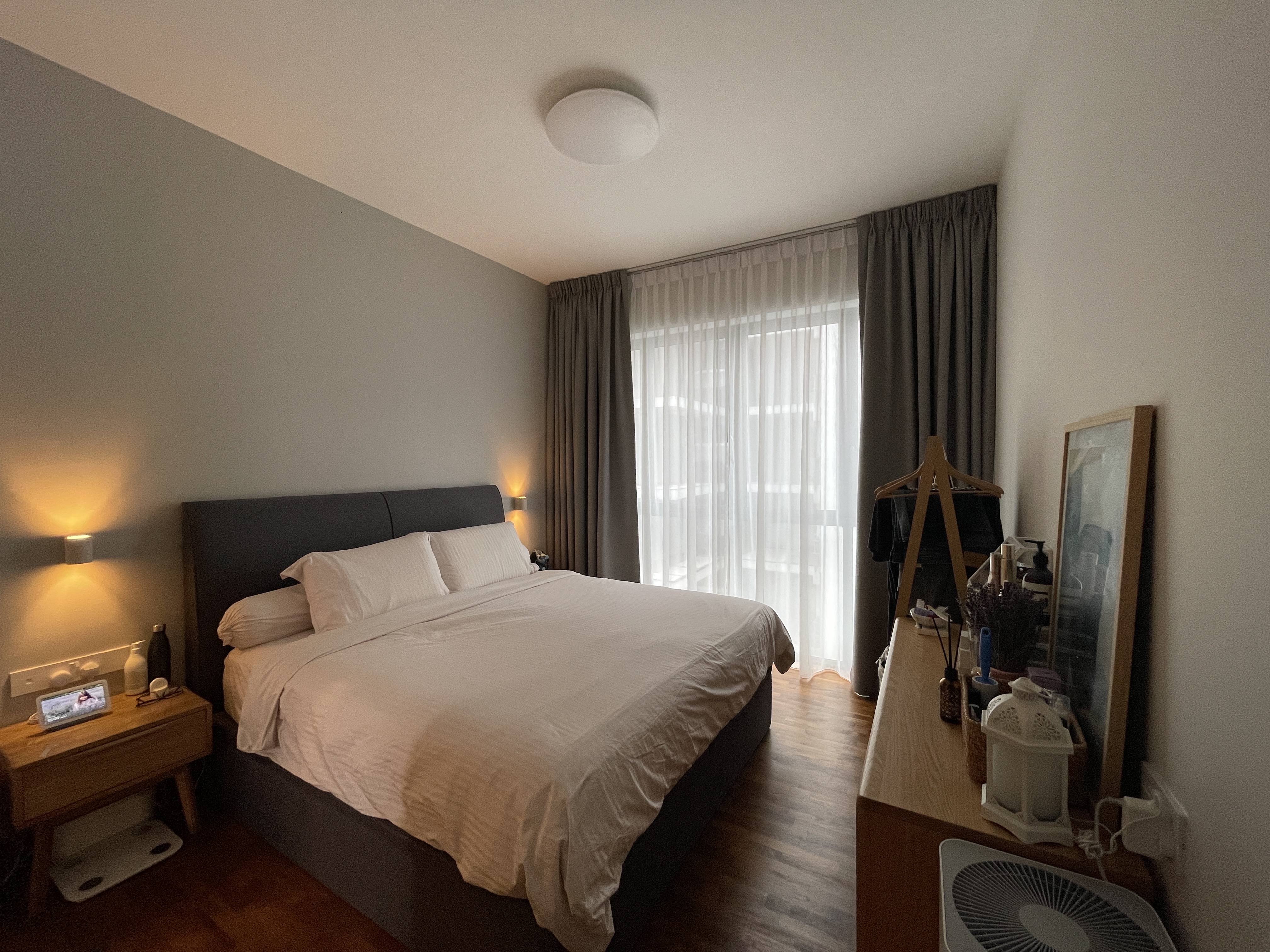 Our Simple and Functional Bedroom  - Modern bedroom with neatly made bed, soft lighting, wooden nightstands, comfortable