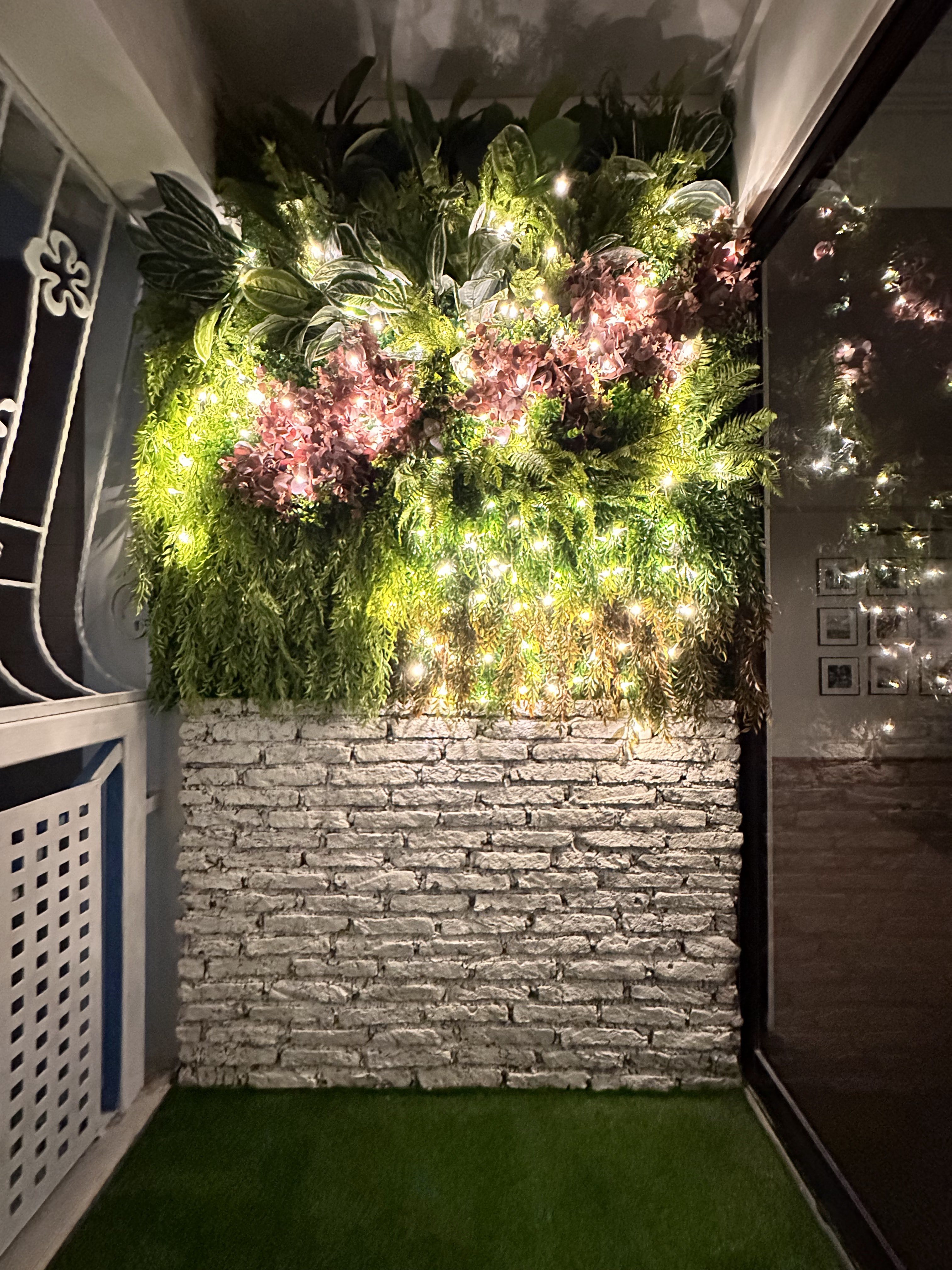 Verde Nook & Vertical Garden - Greenery, artificial plants, fairy lights, stone wall, indoor setting, cozy ambiance