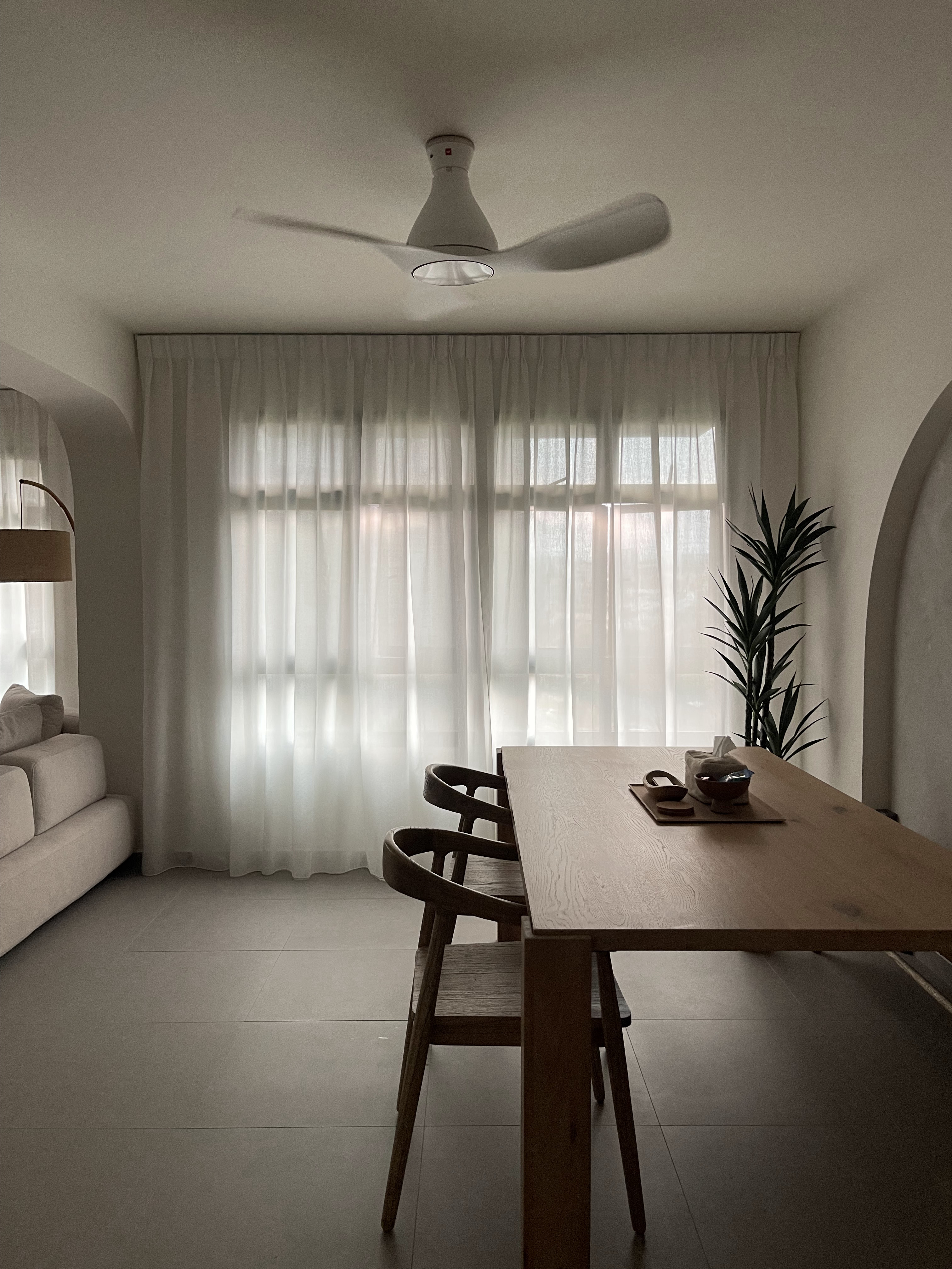 The Dining Area: The Heart of Our Home  - Sunlit room with modern design, beige sofa, wooden dining table, minimalist ceiling