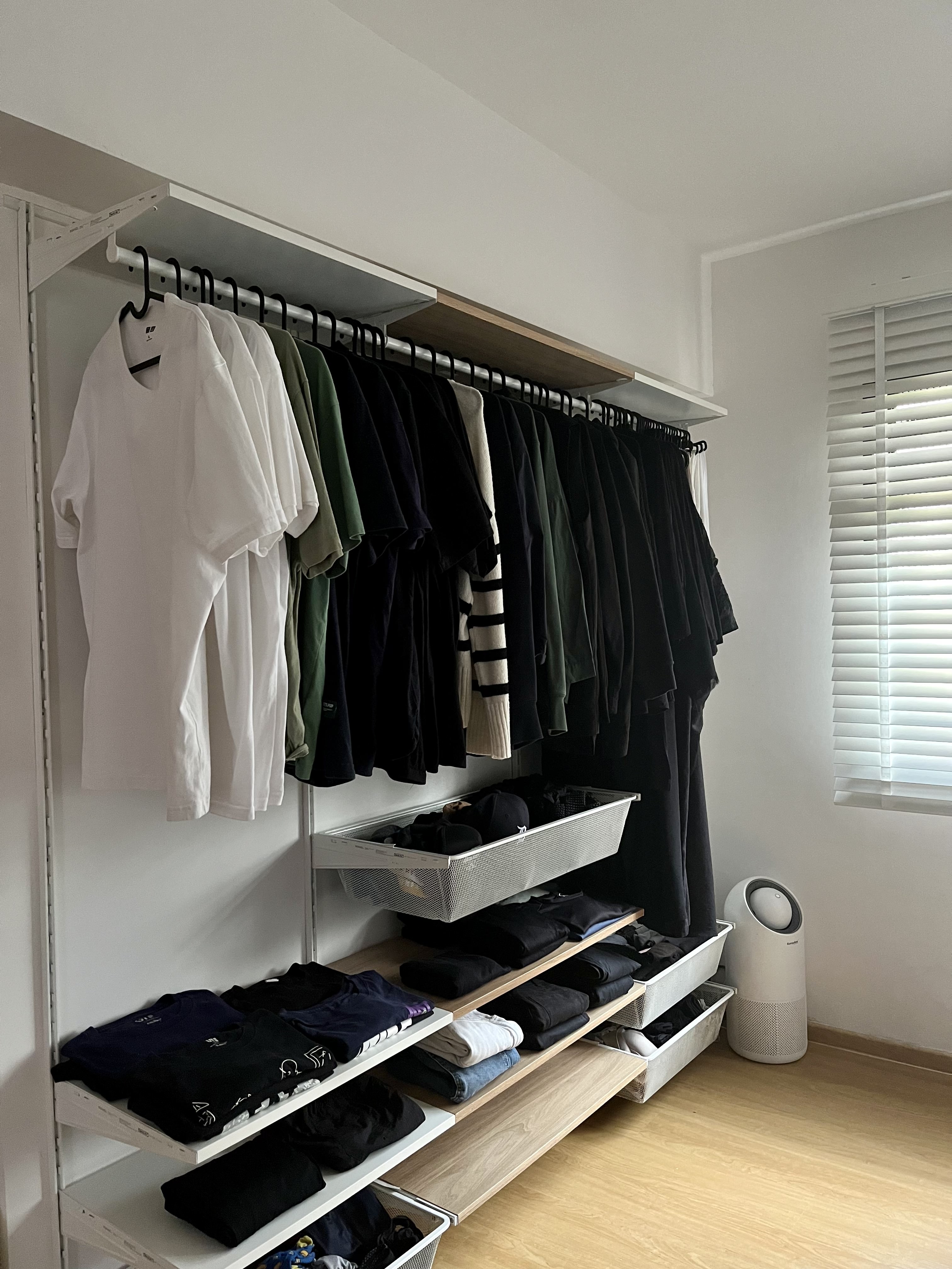 The Zen Zone: A Peek into Our Peaceful Retreat - White wardrobe with black hangers, neatly organized clothes, black and white