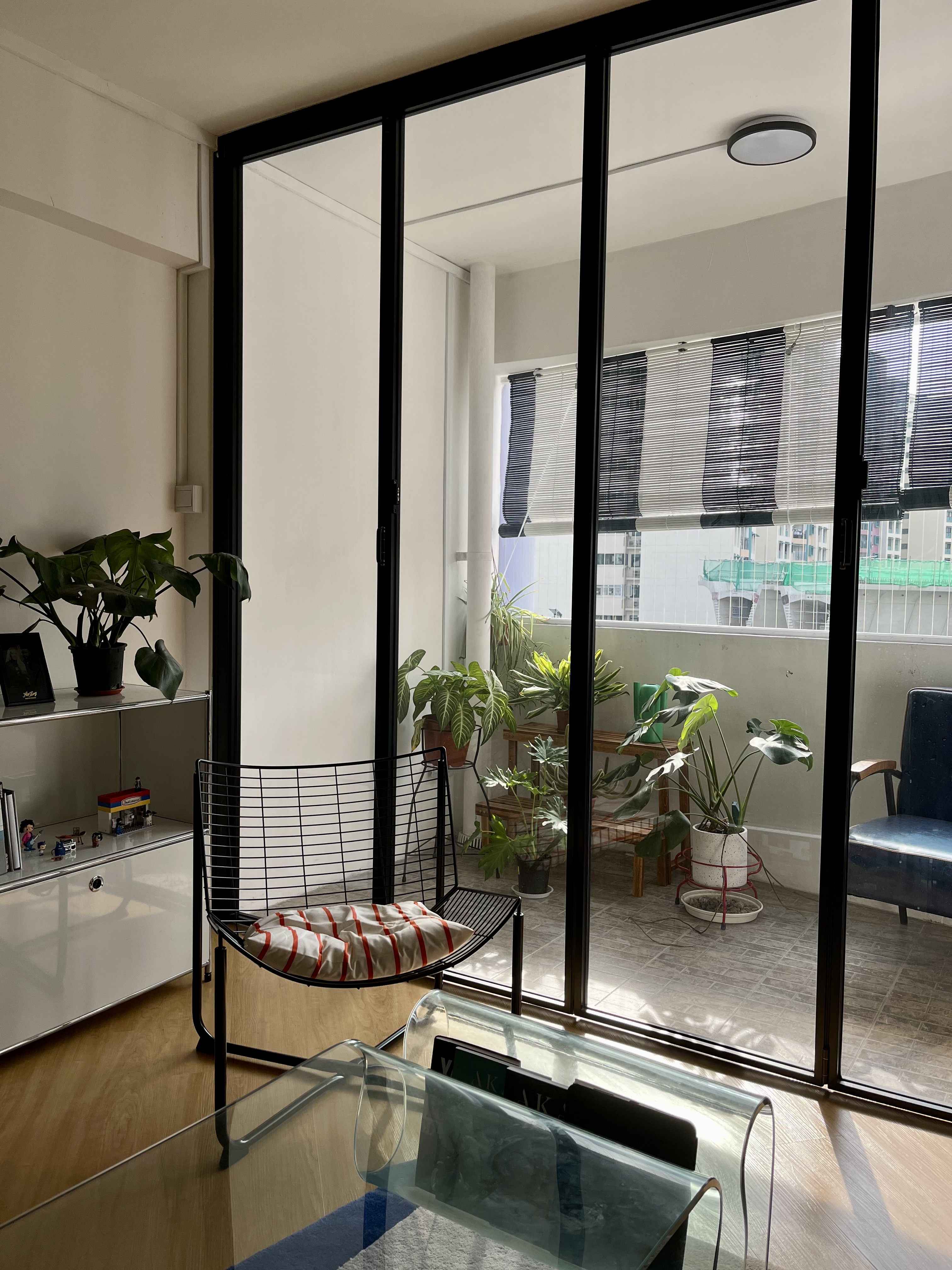 Indoor-Outdoor Living: Creating a Sanctuary at our Balcony - Modern living room with glass doors, indoor plants, black metal