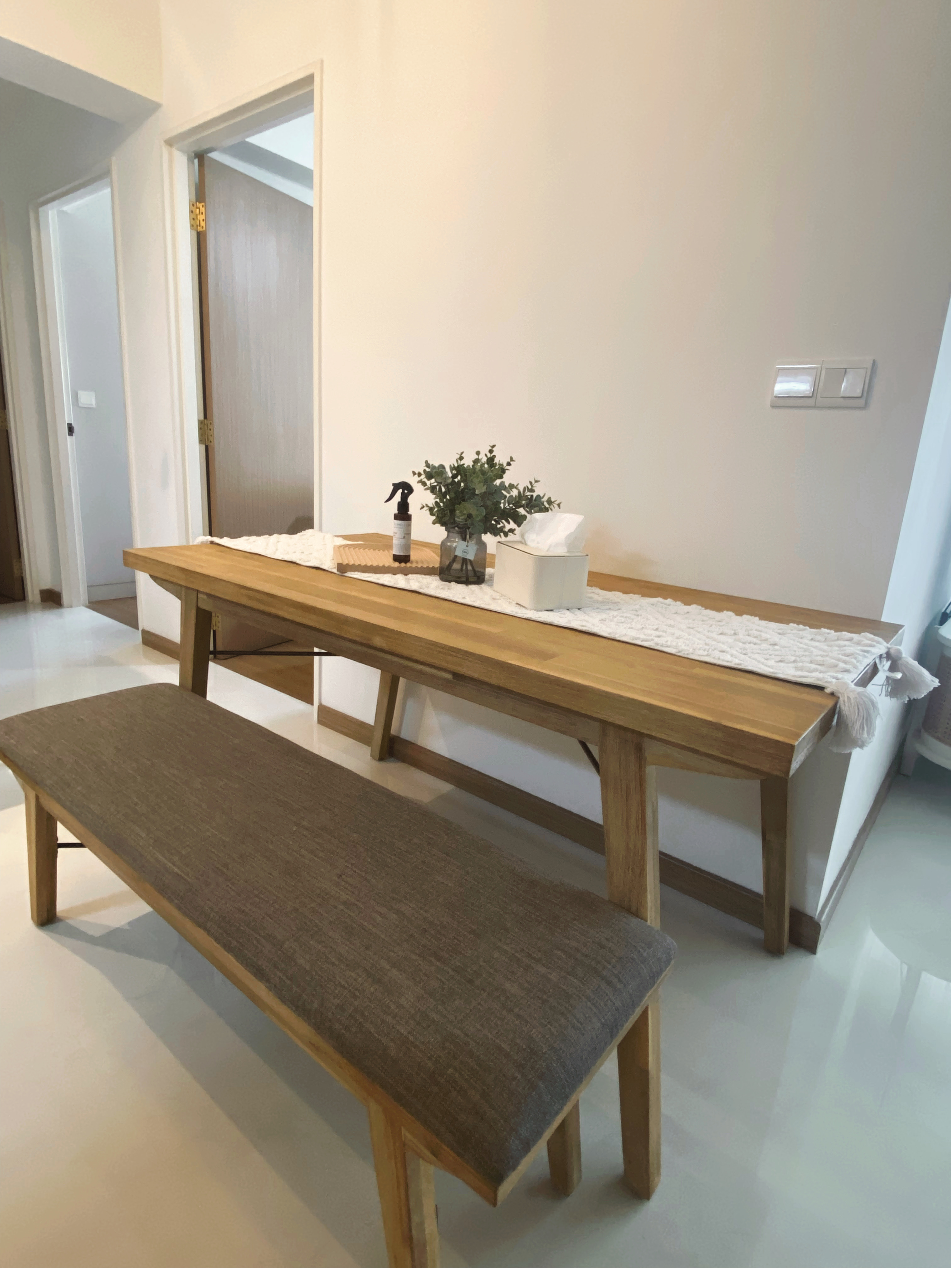 We do Dining but on the Move - Wooden bench, minimalist design, light-colored walls, natural light, wooden table, textured