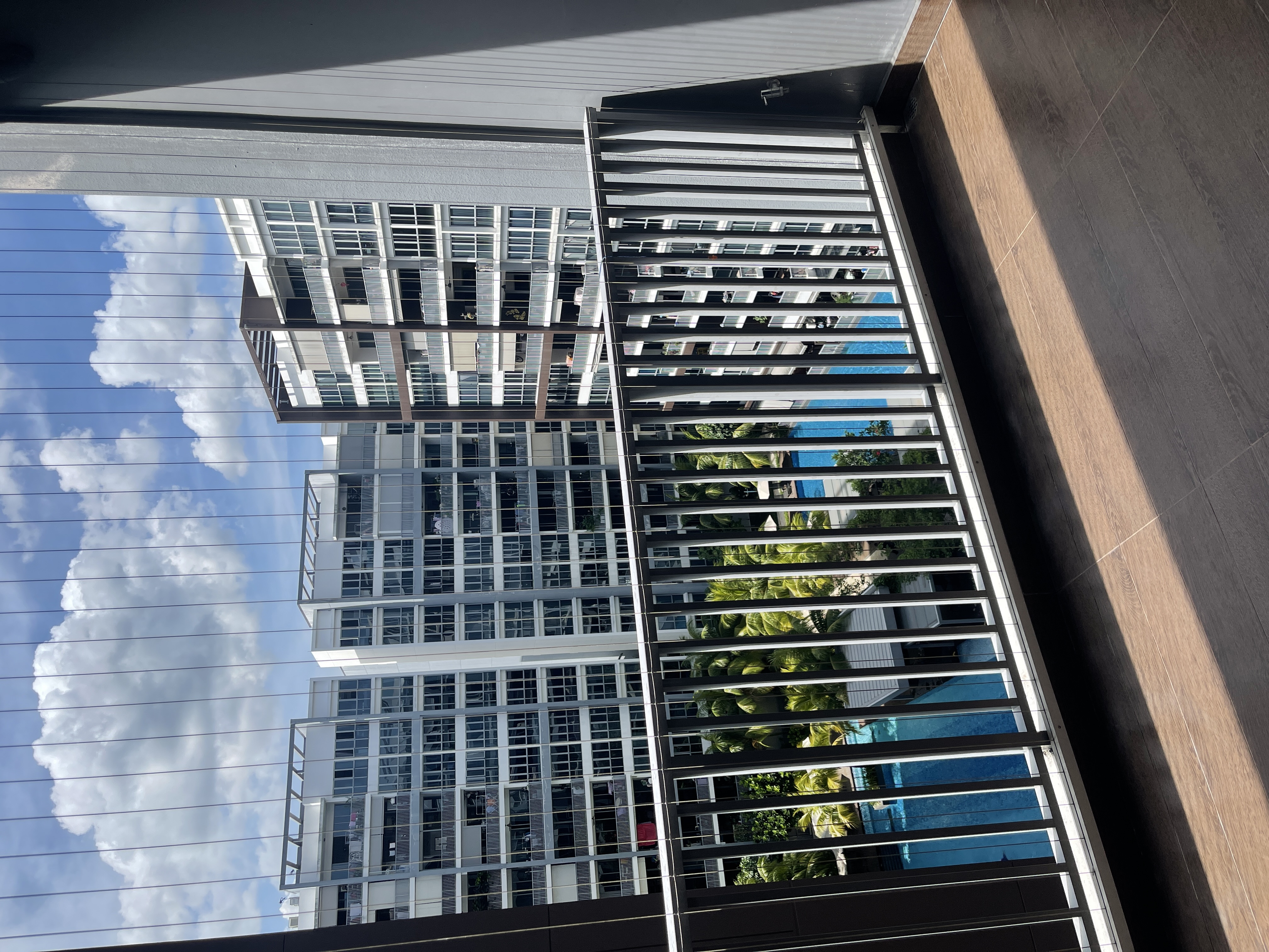 Come hang out in my indoor jungle - Modern skyscraper facade, tall buildings, urban landscape, blue sky, clouds, sunlight