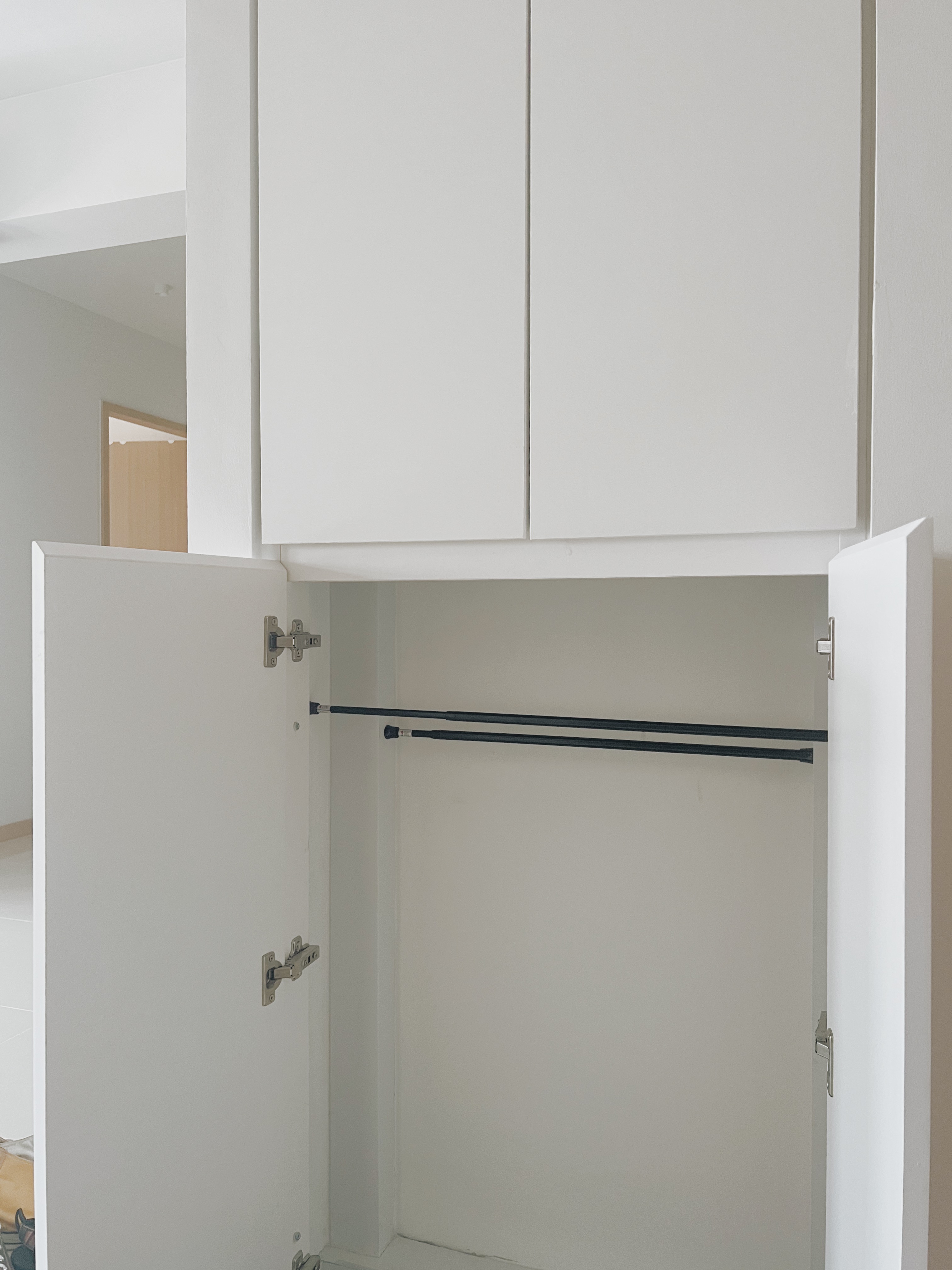 Shoes, Clutter, and $13: Our DIY Journey to a Neater Entryway - White kitchen cabinets, open upper cabinet doors, minimalist