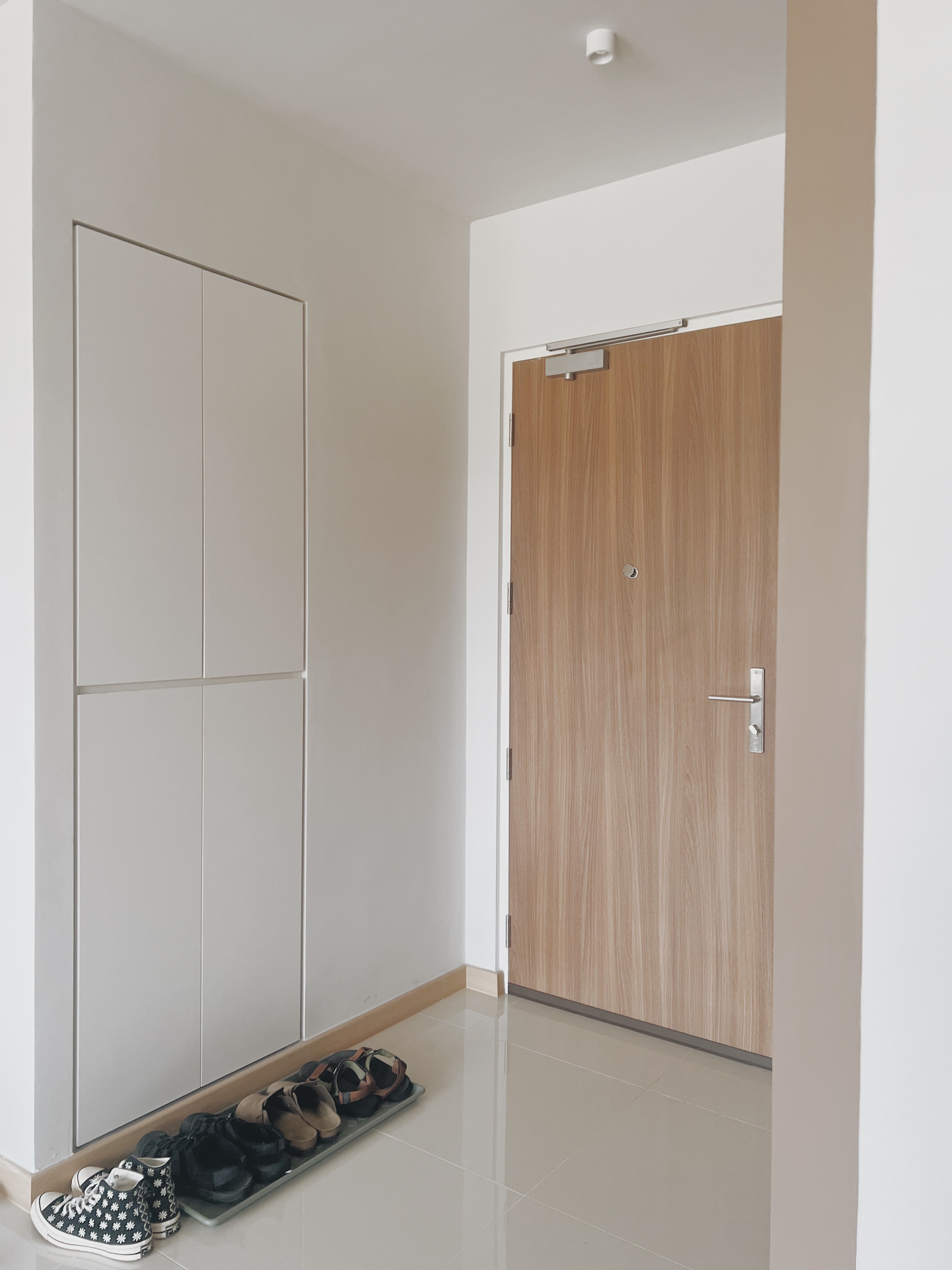Shoes, Clutter, and $13: Our DIY Journey to a Neater Entryway - Wooden door, white wall, minimalist design, modern interior