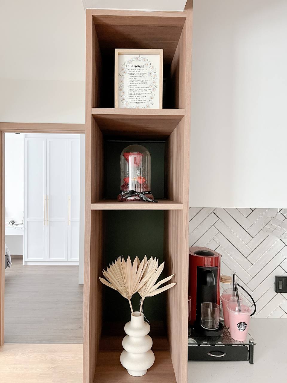 Transforming spaces and elevating spaces with Faux Plants - Wooden shelf, minimalist design, open shelving, white cabinets