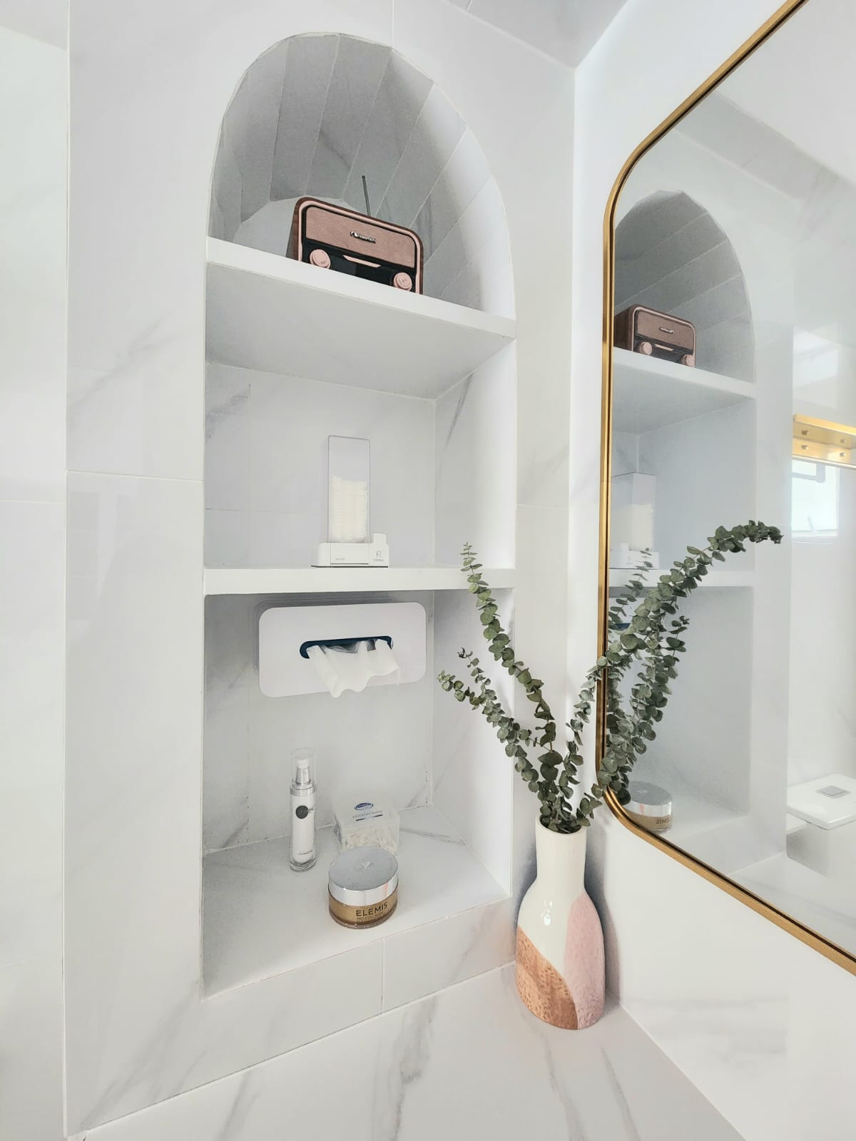 Boosting your happiness with home plants  - White marble bathroom vanity, minimalist design, floating shelves, arched