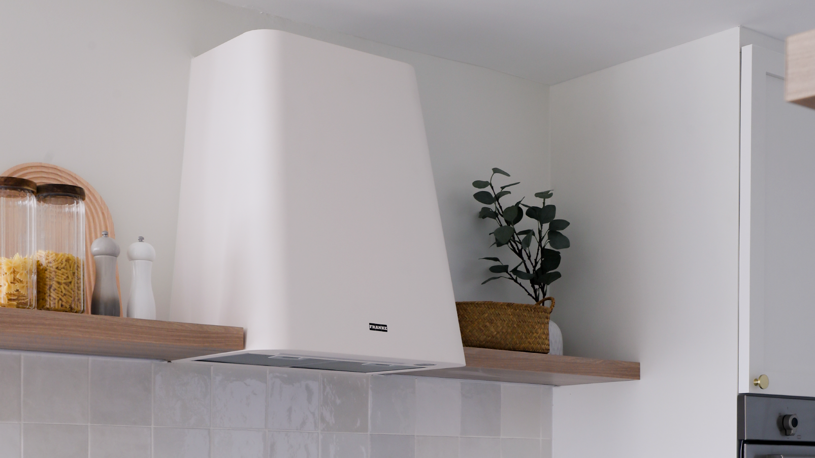 Softening the looks of our home with “plants” - Clear glass jars, wooden shelf, pasta, salt and pepper shakers, white kitchen