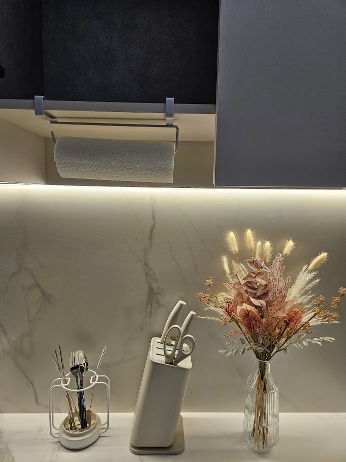 A Smart and Functional Kitchen - Organized kitchen counter, modern utensils, sleek cutting board, decorative flowers, elegant