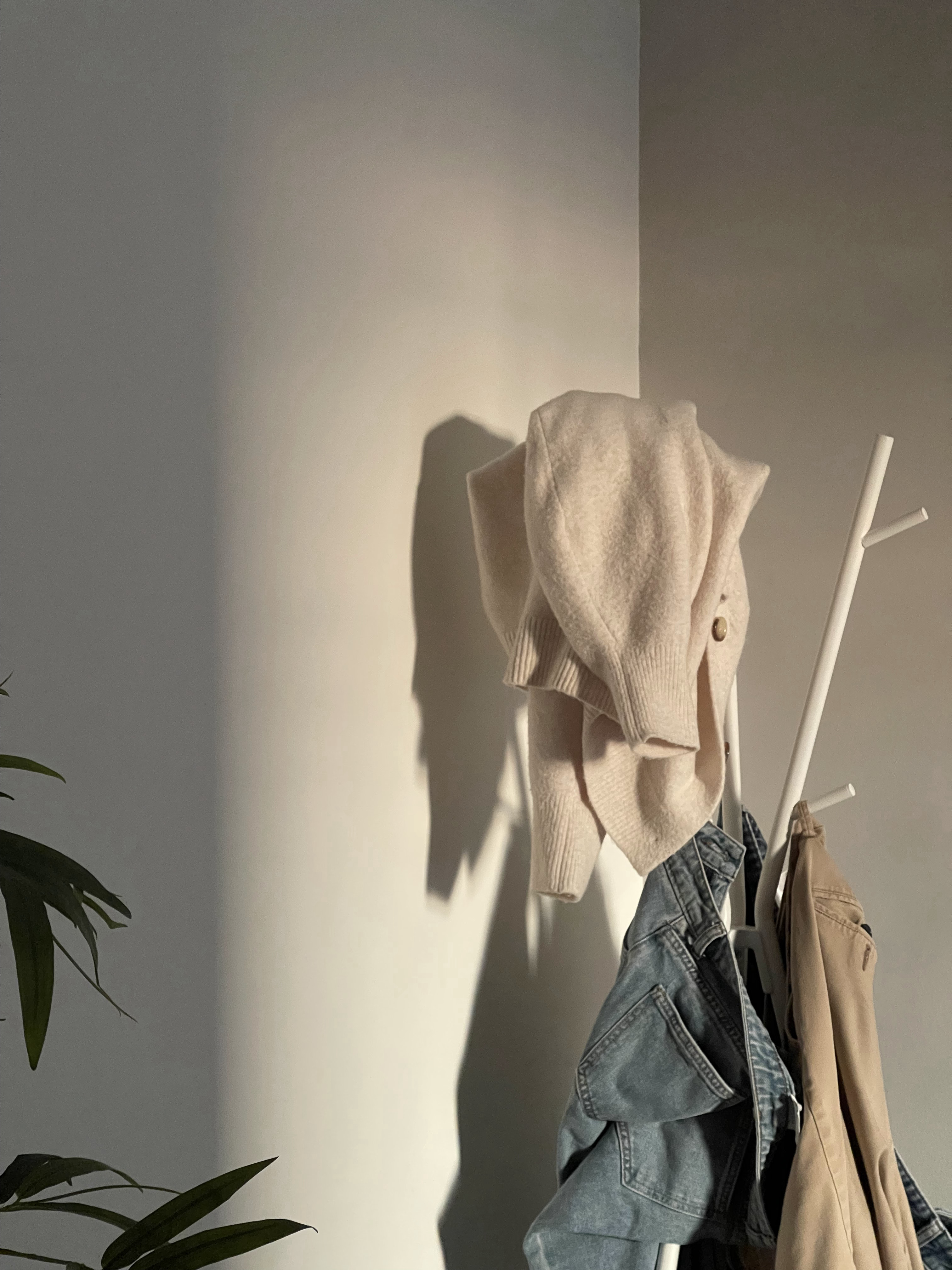 Our Atypical Master Bedroom: No L-shaped Wardrobe for us - Soft, muted beige sweater, shadowy figure, hanging clothes, denim