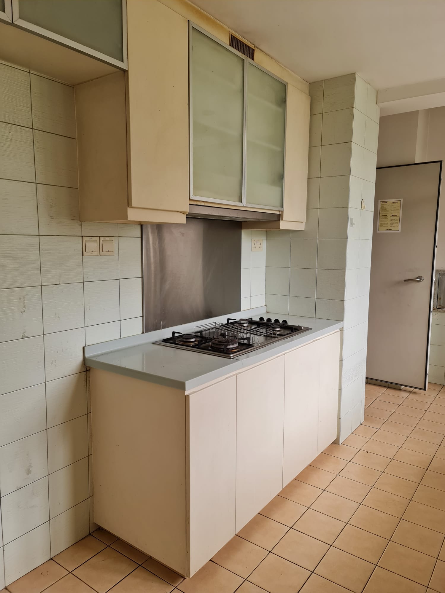 Redesigning an old condo unit to be inviting and warm - Kitchen cabinetry, tiled walls, light beige cabinets, stainless steel