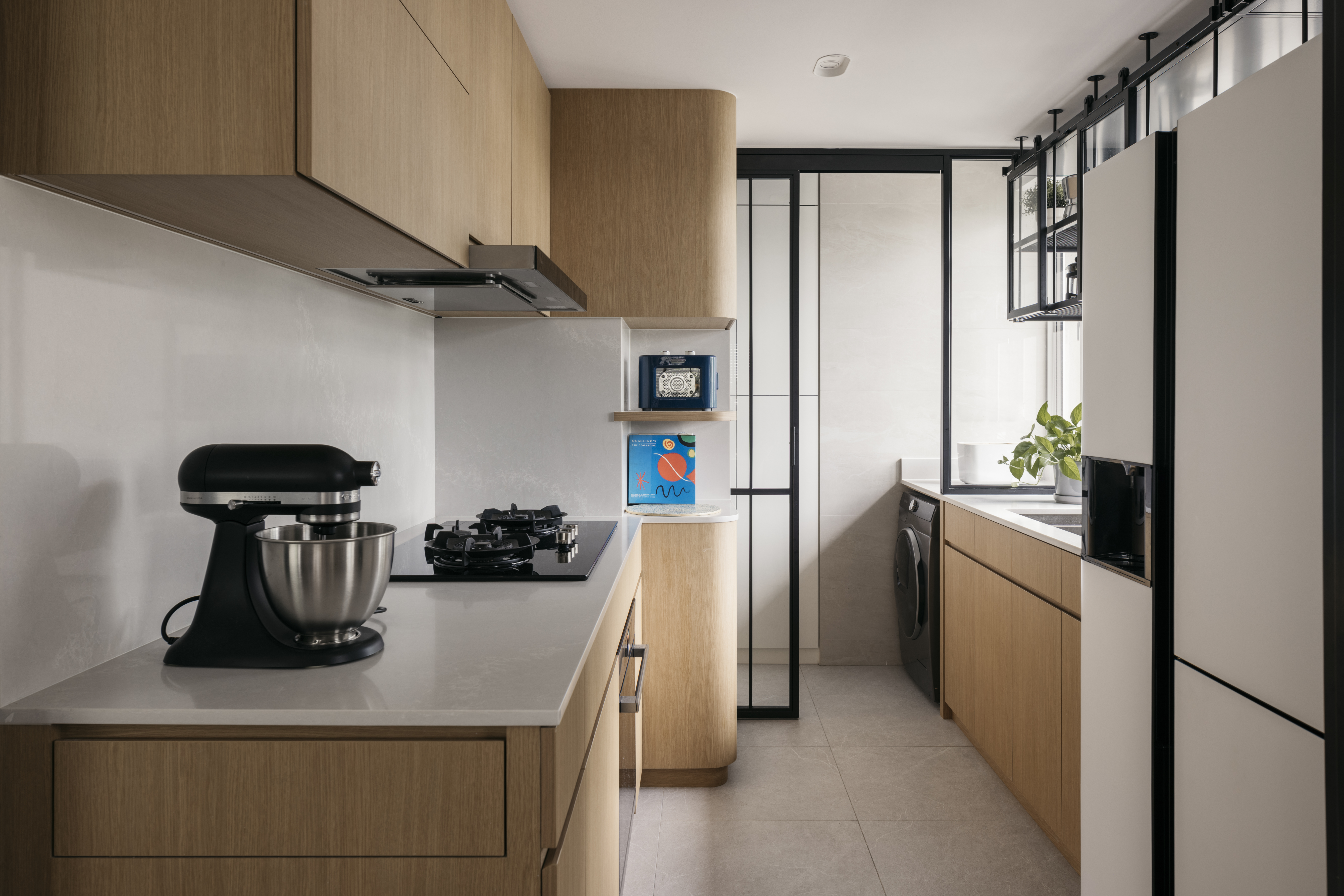 Redesigning an old condo unit to be inviting and warm - Wooden cabinets, modern kitchen, stainless steel mixer, black stove