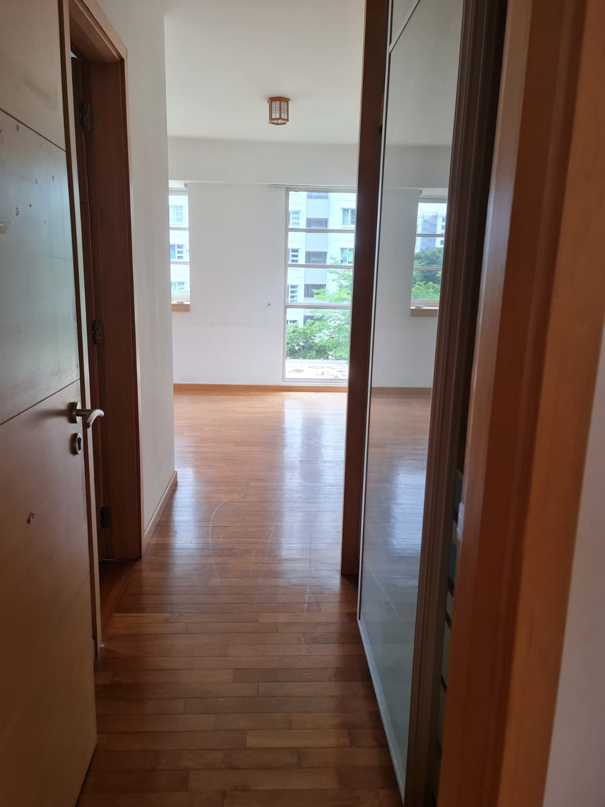 Redesigning an old condo unit to be inviting and warm - Wooden hallway, open door, wooden floor, large windows, natural