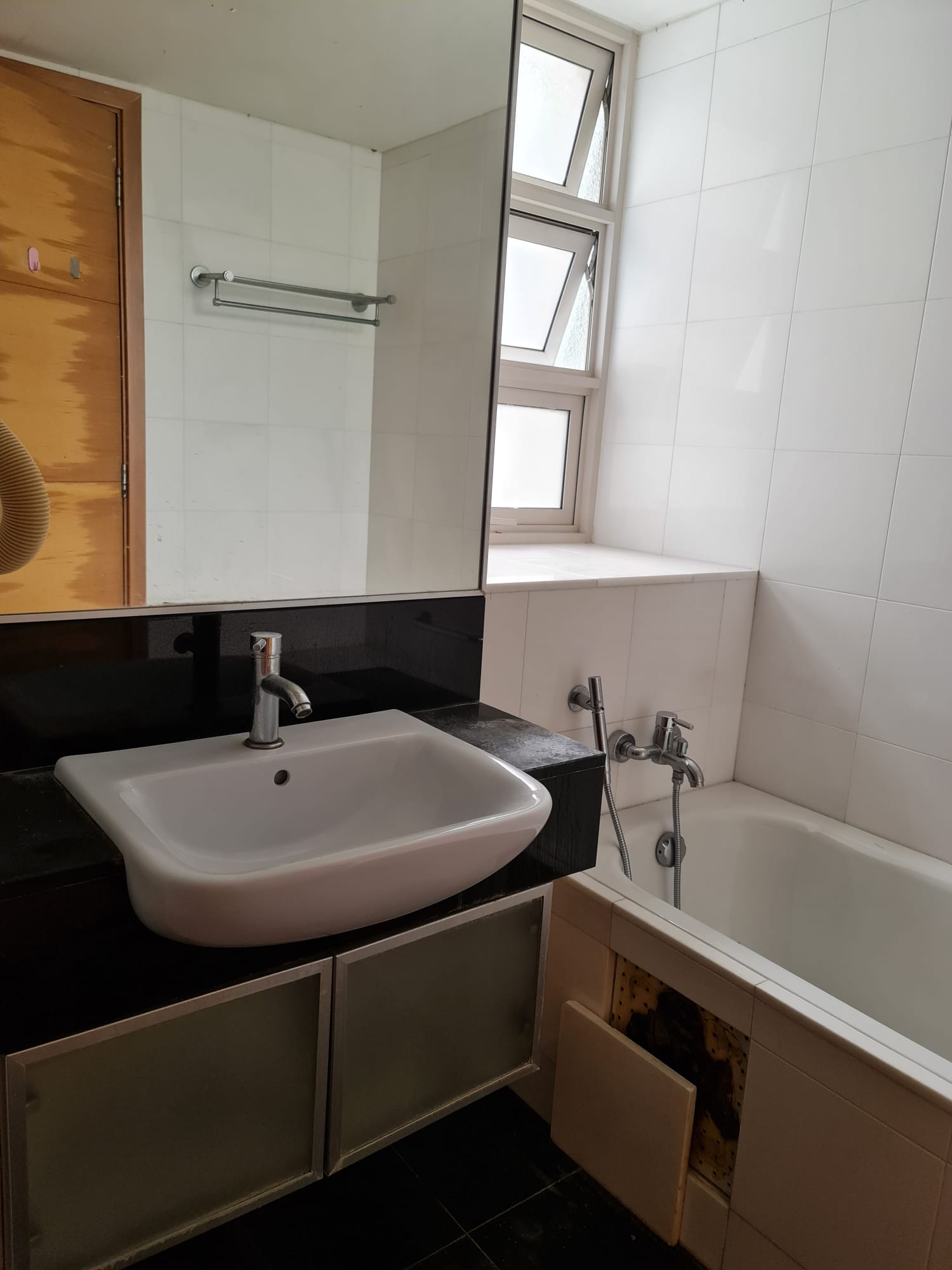 Redesigning an old condo unit to be inviting and warm - White bathroom vanity, black countertop, modern sink, mirror above