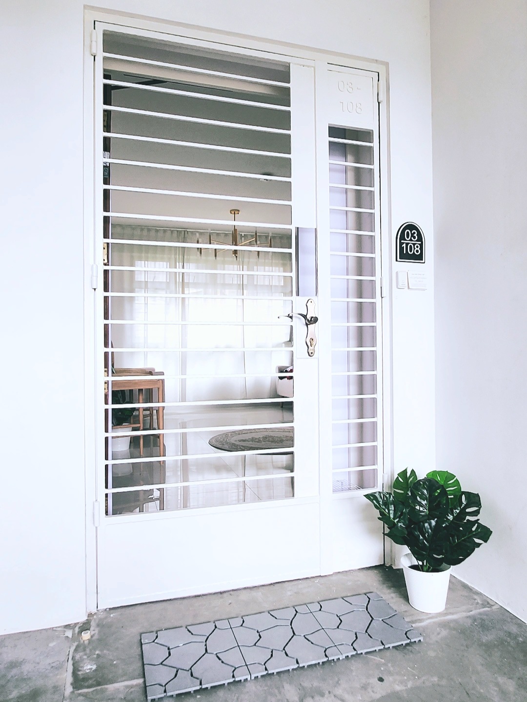 Move-a-round plants - Glass door entrance, white exterior, modern design, number 108, indoor view, white blinds, indoor