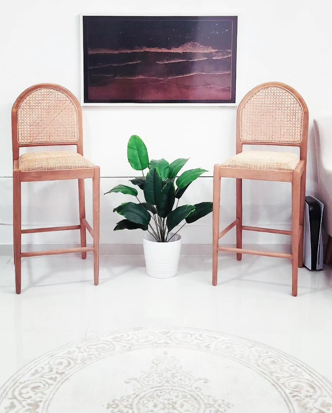 Move-a-round plants - Wicker chairs, minimalist decor, natural wood finish, white potted plant, serene interior, modern