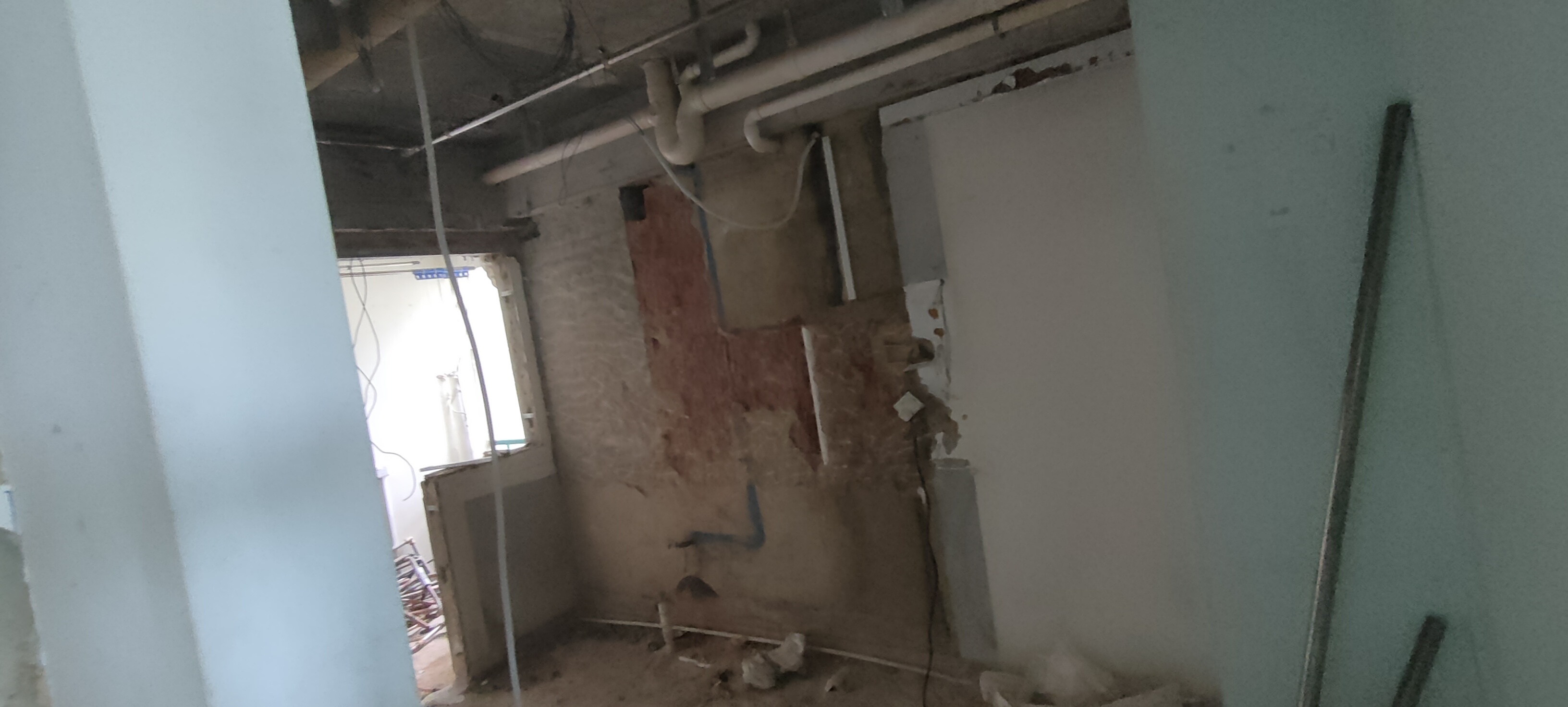 the heart of our home--Our kitchen! - under construction, exposed pipes, unfinished walls, debris on floor, electrical wires